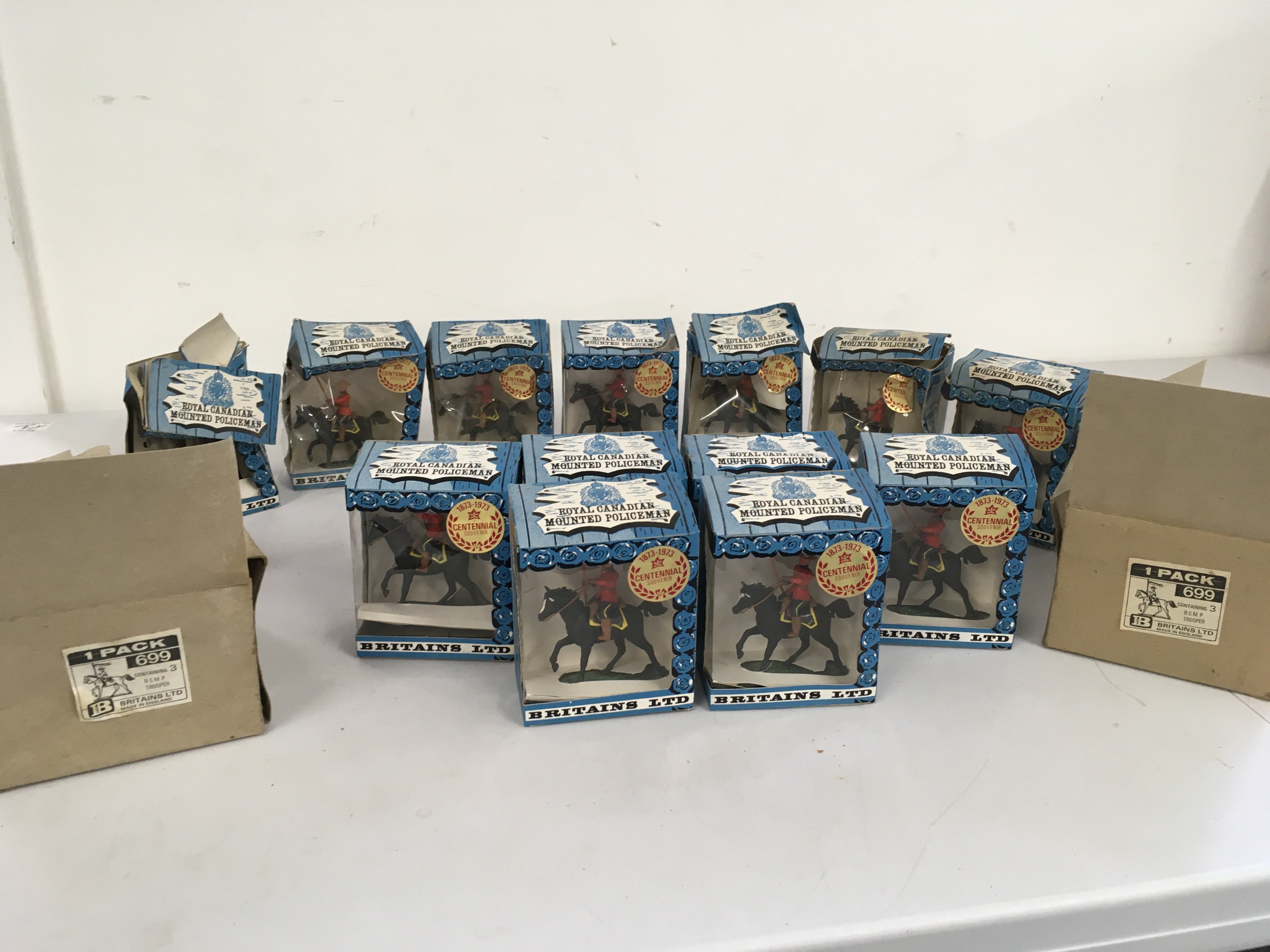 A collection of 13 boxed Royal Mounted Canadian Policeman by Britains. 7 boxes in worn condition 6 are still in their packaging boxes of 3 each. No reserve