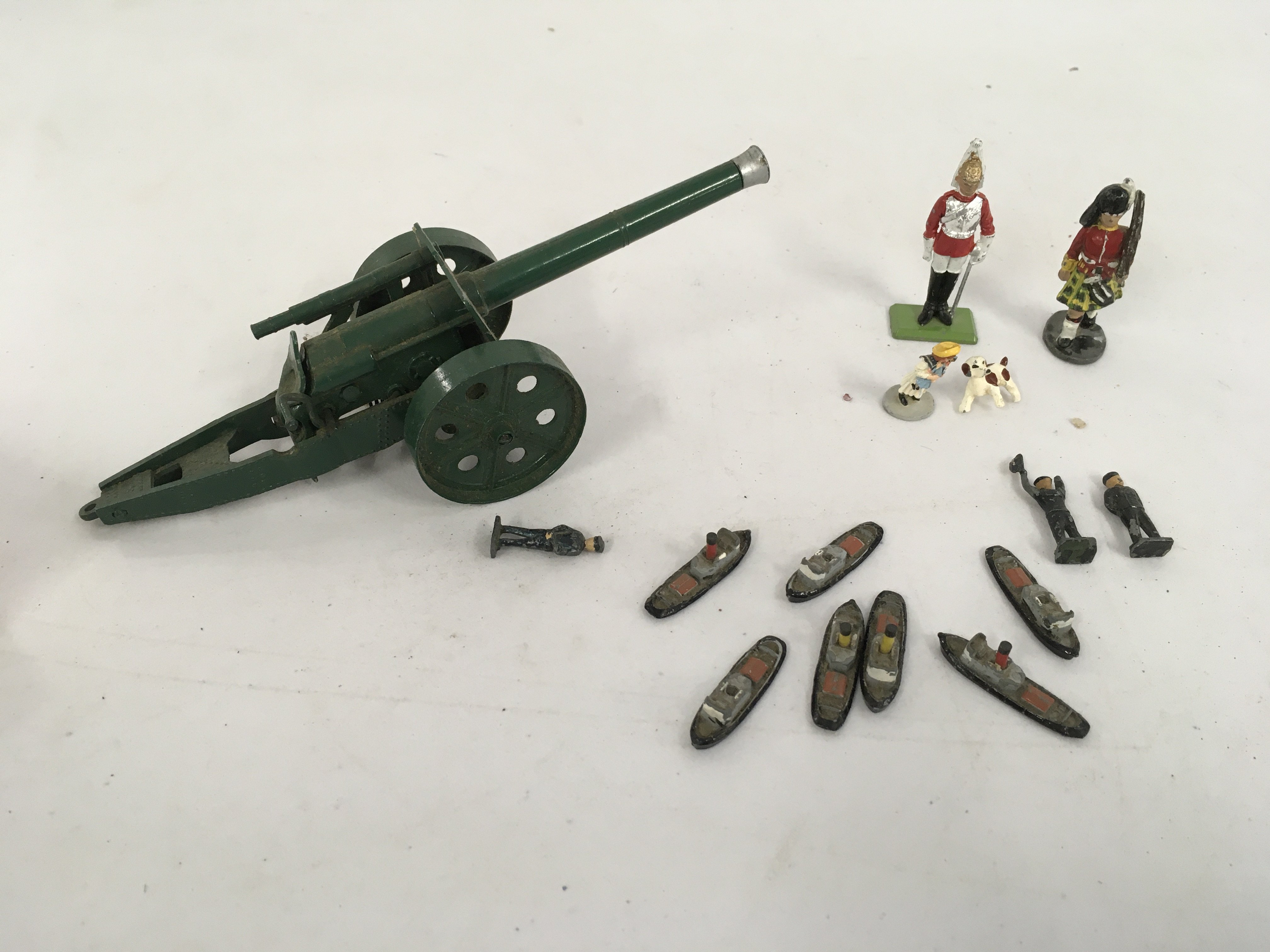 A artillery model gun by Britains and other figures by Crescent and others. No reserve