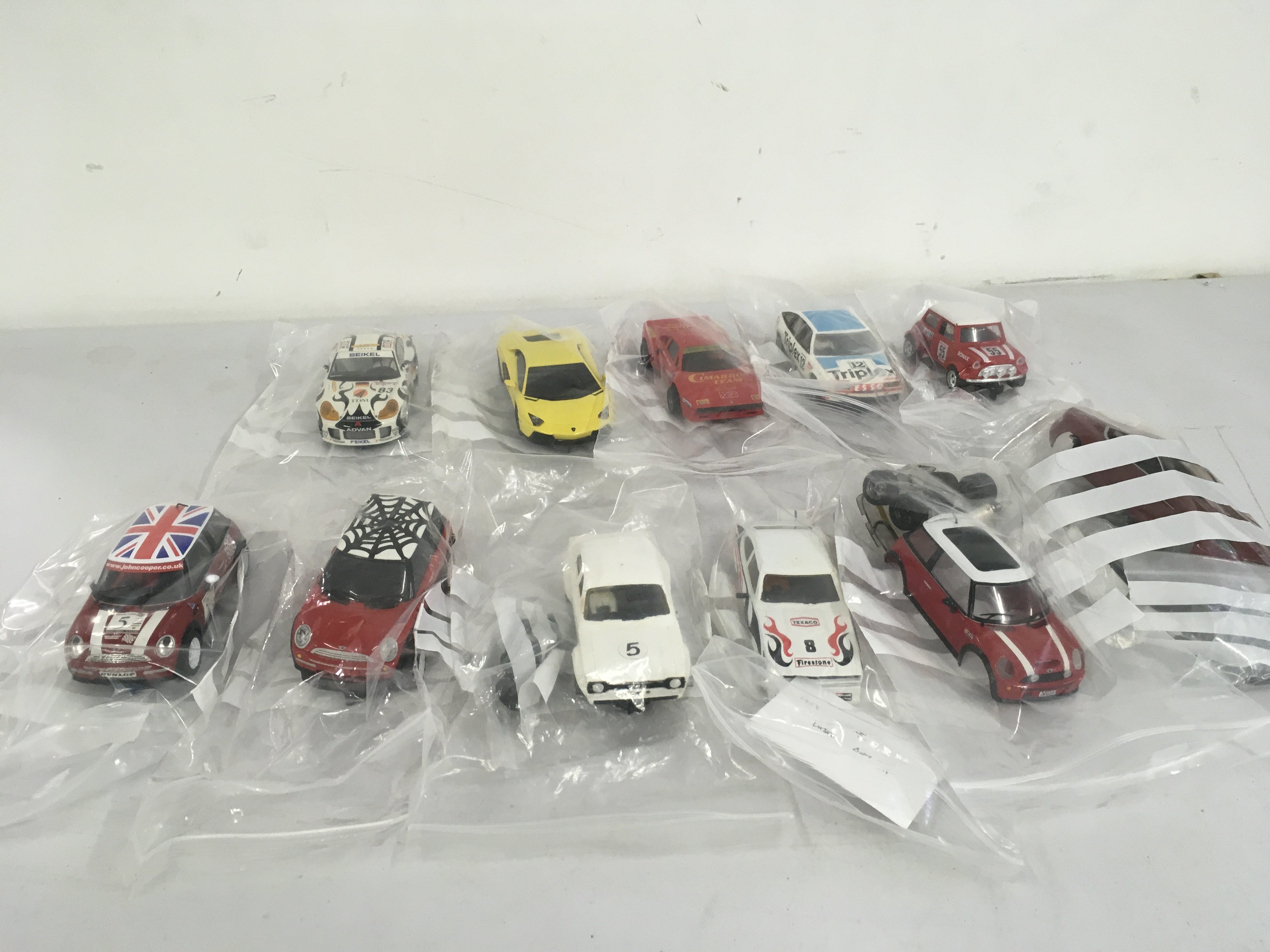 A collection of Scalextric cars some ready to run and also some for spares and repair. No reserve