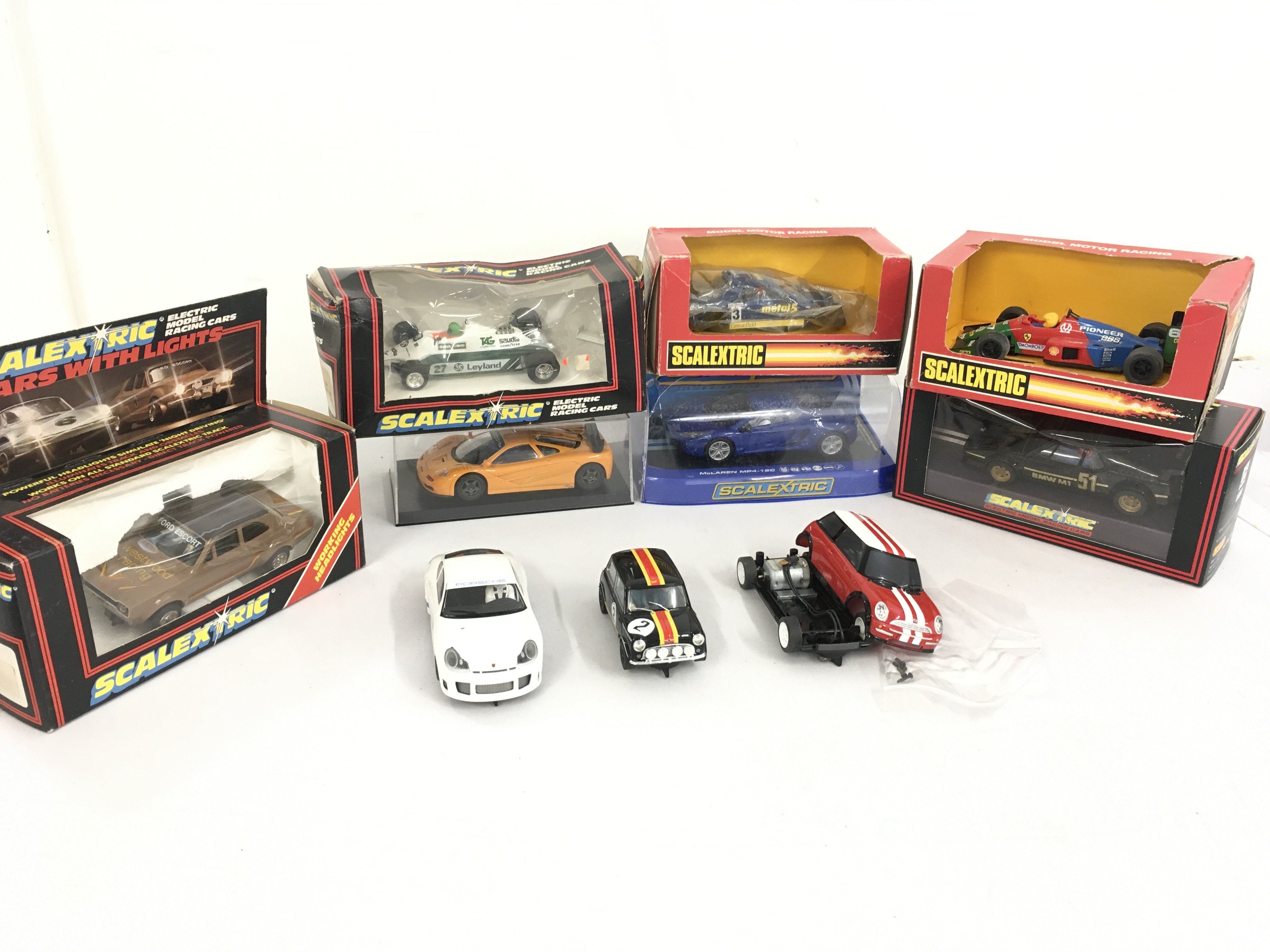 A collection of 10 Scalextric cars, boxed and loose. Most in running order . No reserve