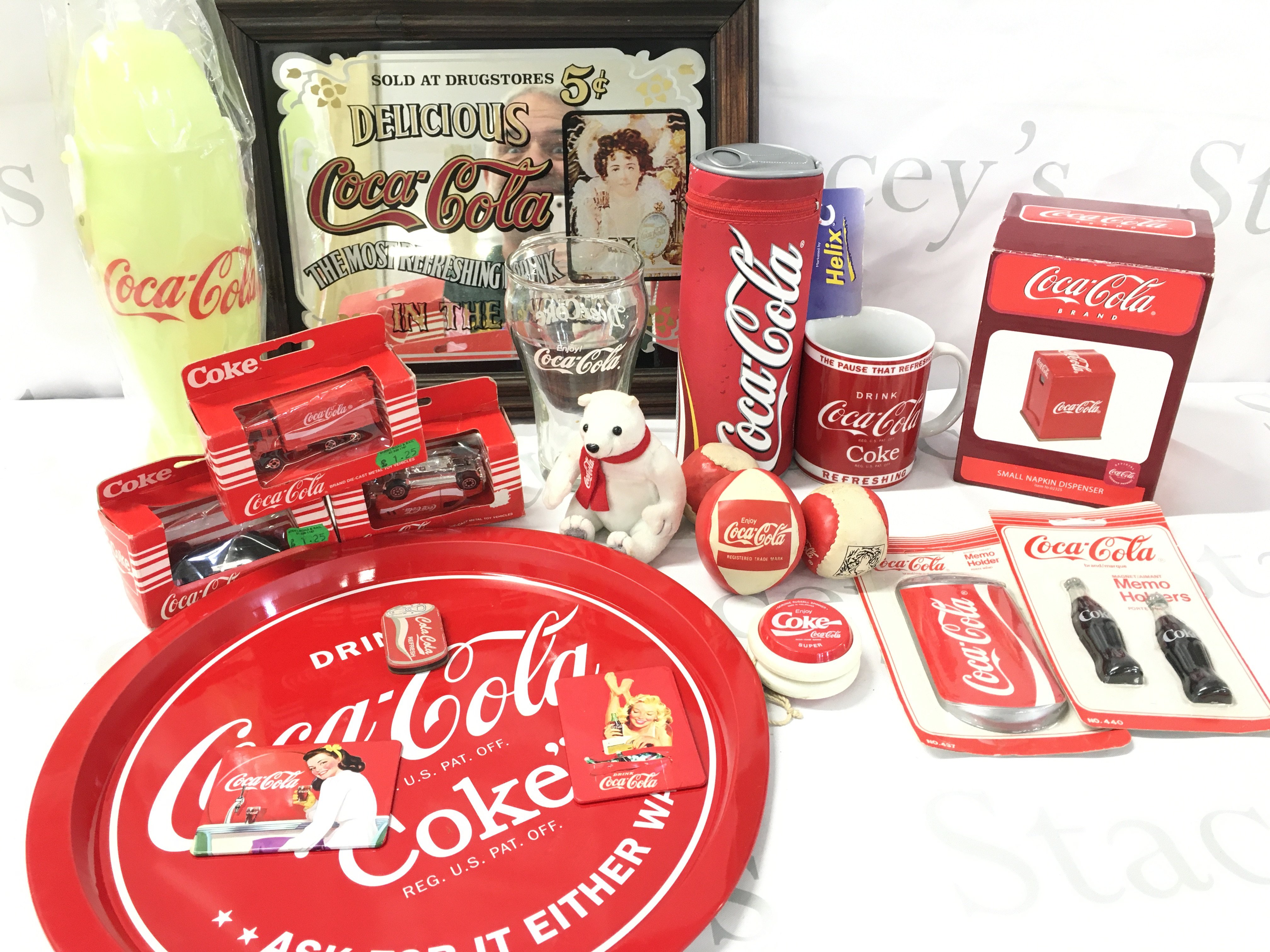 A Collection of Coca-Cola Merchandise. Includes a Coke Mirror. No Reserve.