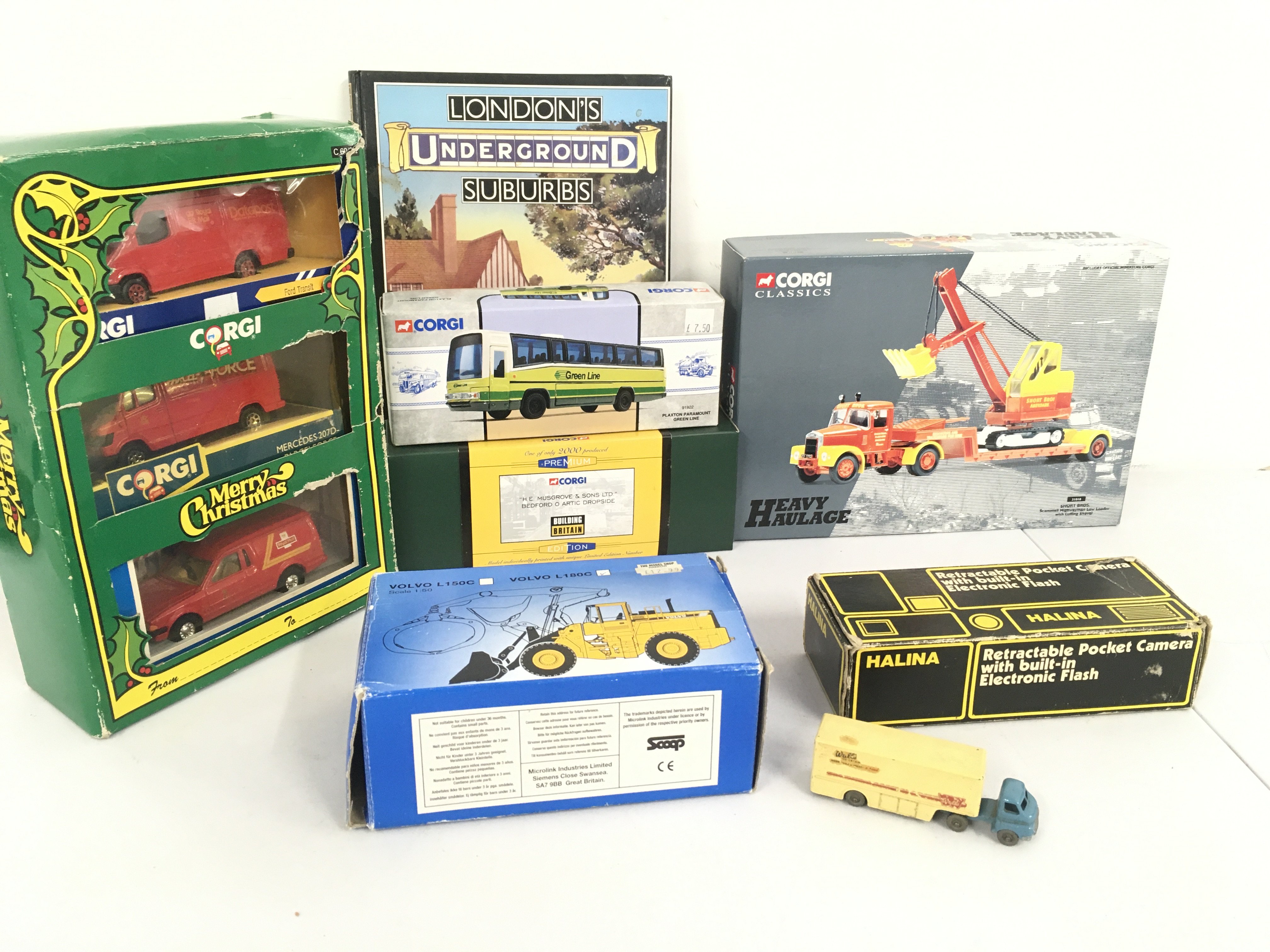 A collection o boxed diecast vehicles by Corgi etc. also includes a loose Matchbox no.2 Articulated lorry Walls ice cream. A boxed Halina pocket camera and book on London suburbs included. Also includes Heavy Haulage Scania T King Trailer with tower Crane load .No reserve (2)