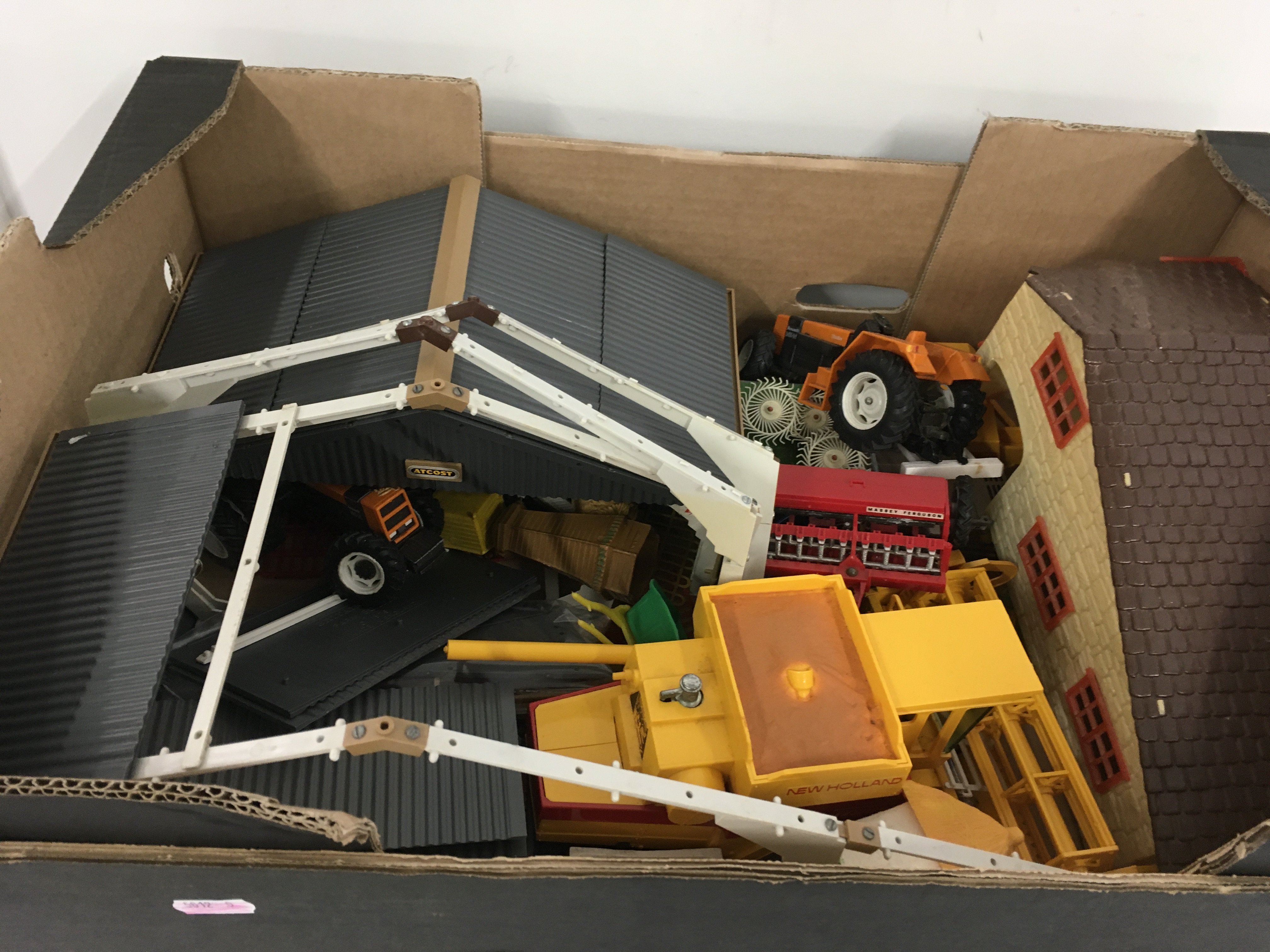 Britains combine harvester tractors plus other farm machinery. Includes 2 Atcost barns plus farm buildings