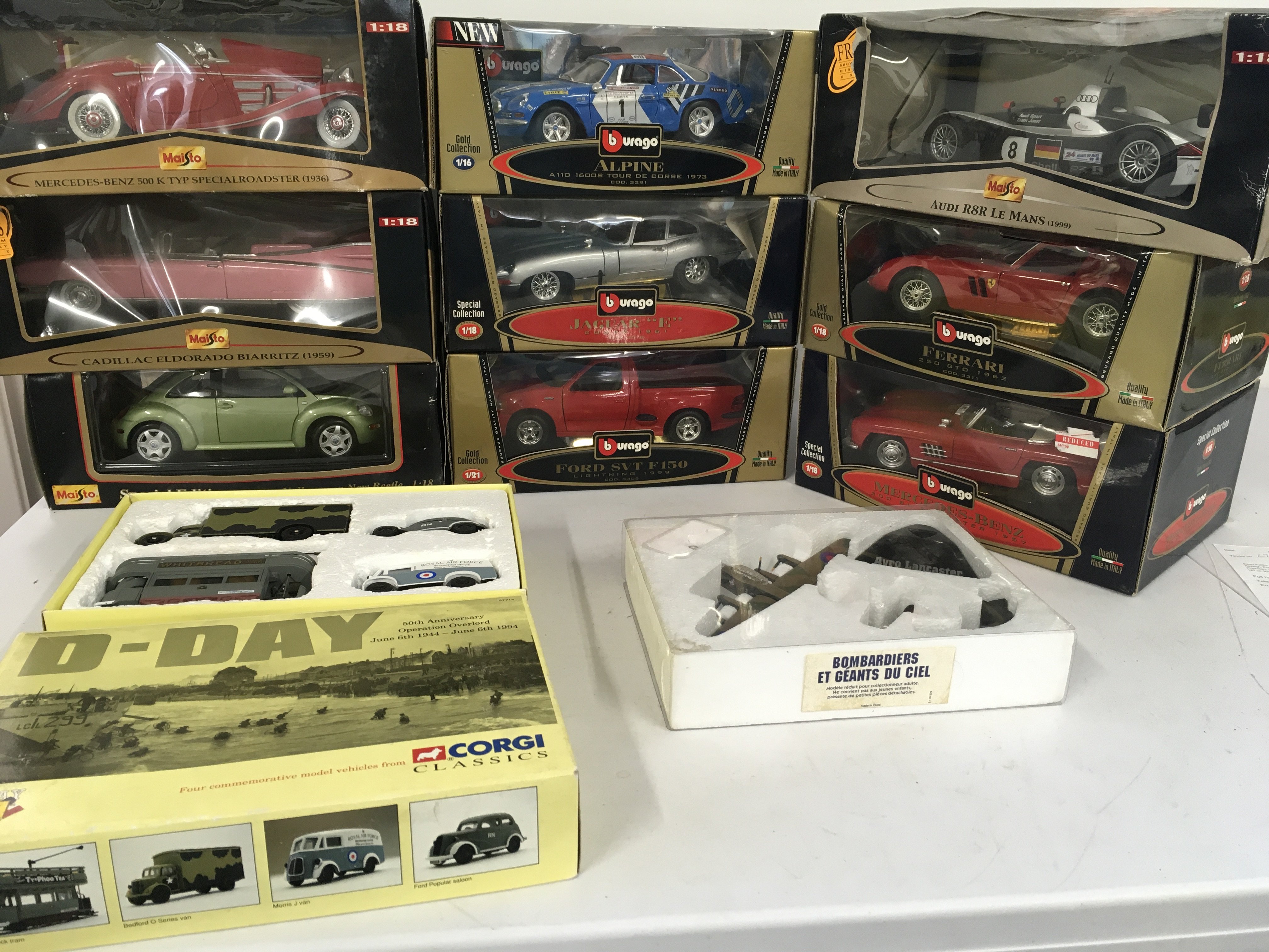 A collection containing burago and Maisto 1..18 scale model cars. Also Corgi D Day set . Includes Model Avro Lancaster. No reserve.