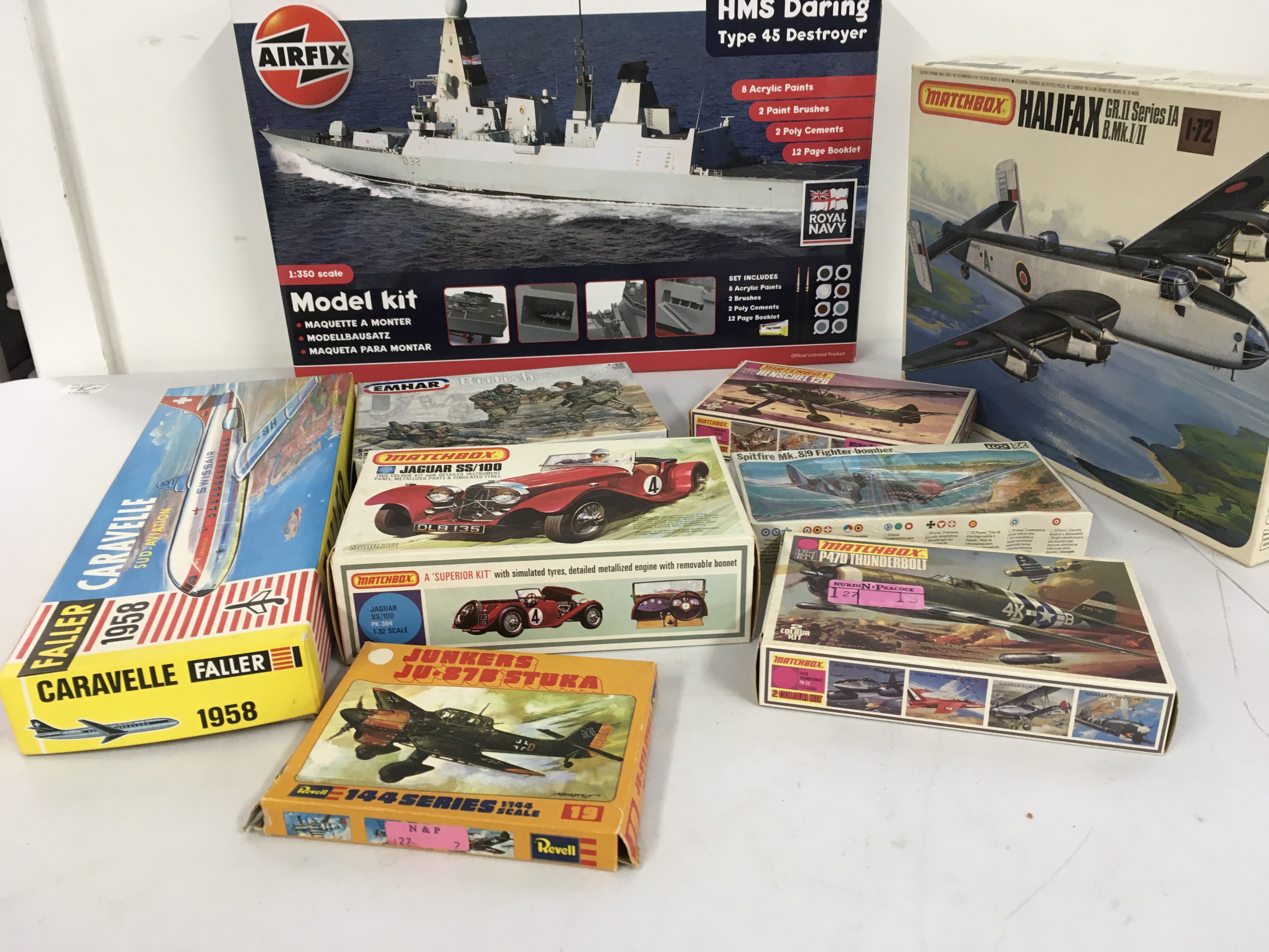 An assorted collection of model kits by Airfix..Matchbox..Faller etc. featuring aircraft, a warship and a car. No reserve.