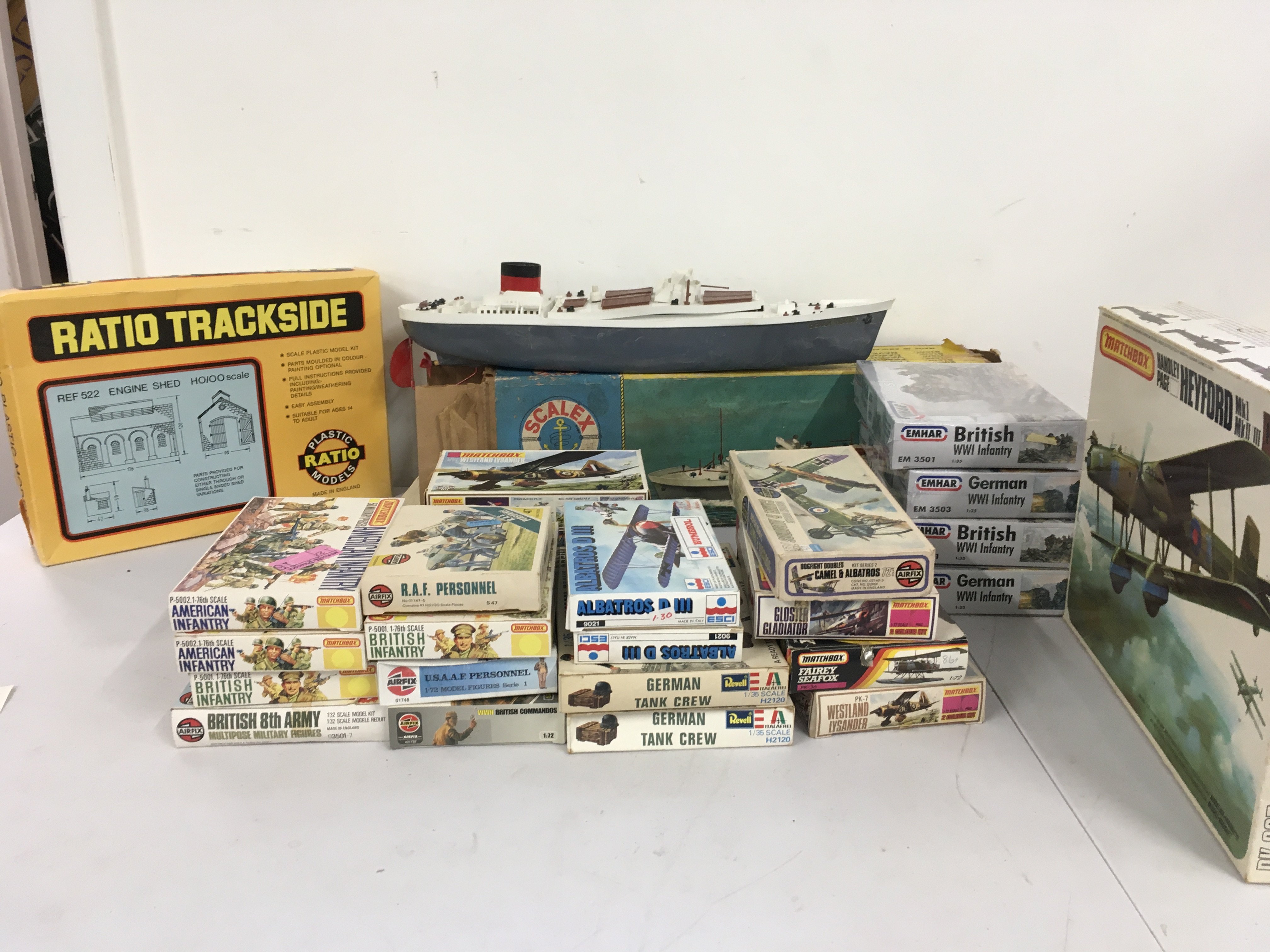 Collection of boxed model sets featuring aircraft and soldiers by Matchbox..Airfix..Revell etc. also includes boxed Scalex Boat OCEAN TRADER. Plus Boxed 00 gauge Engine Shed plastic model kit by Ratio. No reserve