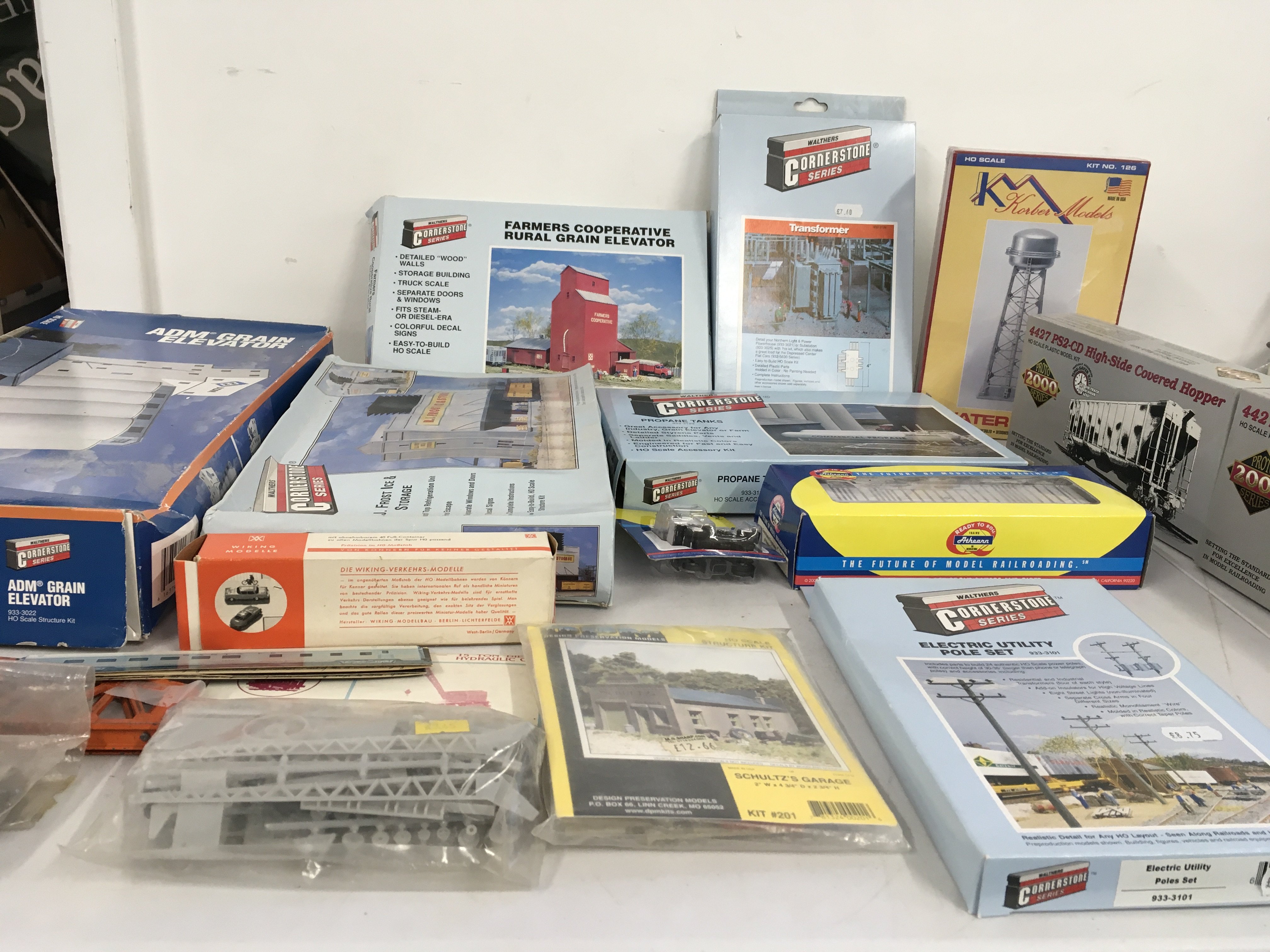 A collection of boxed HO gauge model buildings and railway vehicles. Both kits and ready to run. Manufacturers include Walthers..Proto 2000..etc. no reserve