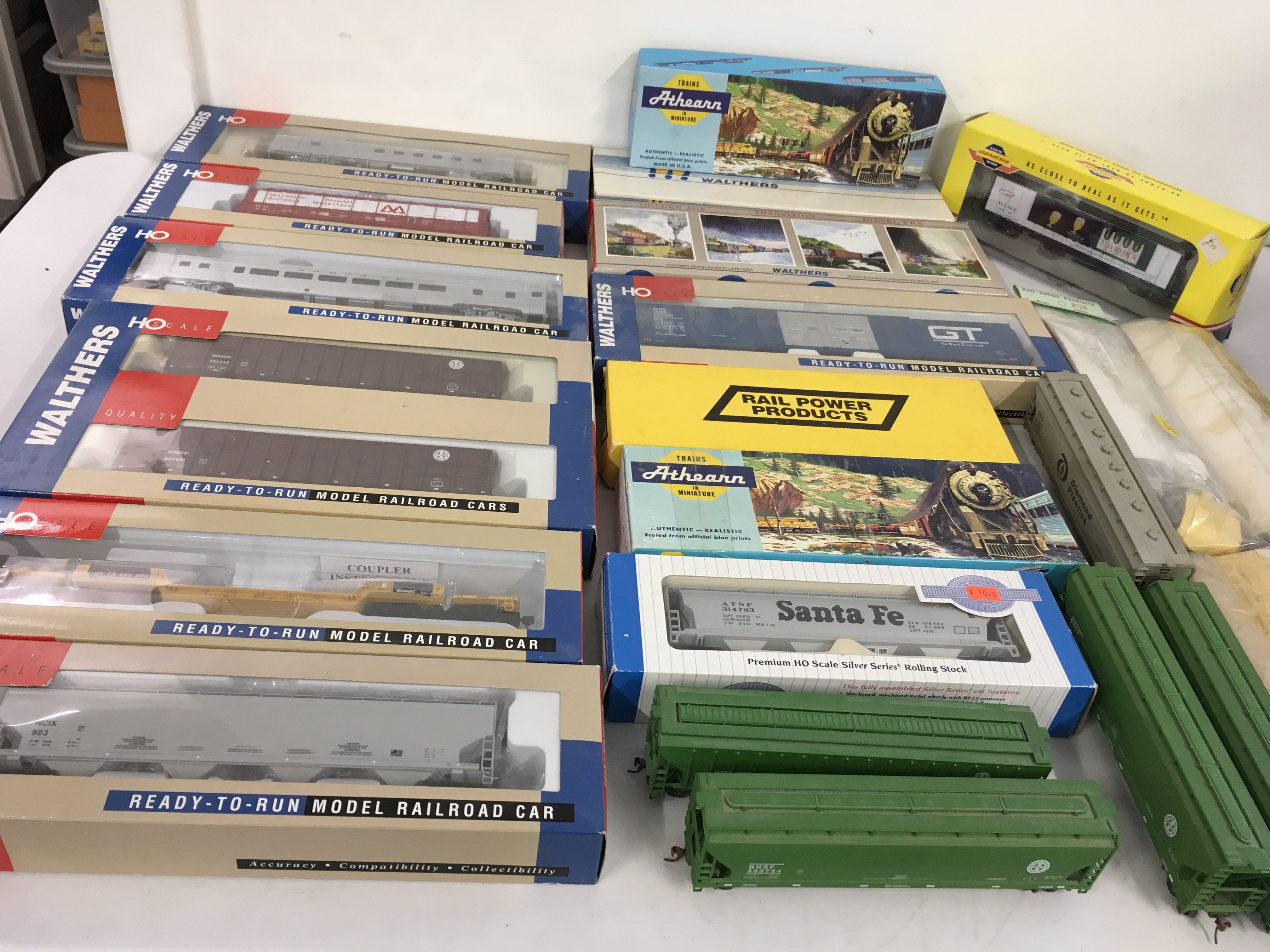 A collection of boxed and loose HO gauge model railway cars and wagons in both kit and ready to run form. Manufacturers include Walthers..Athearn etc. no reserve