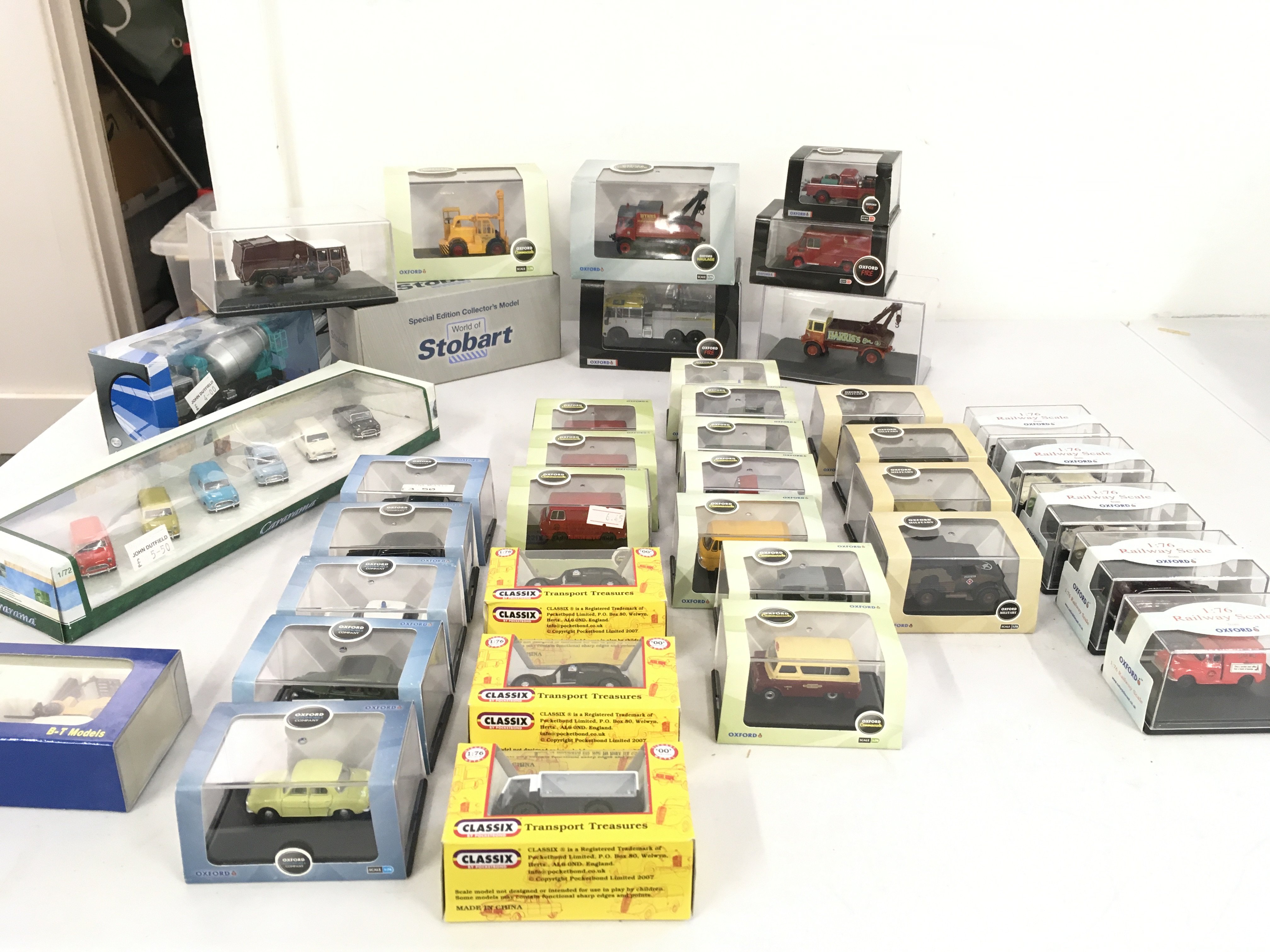 A collection of diecast model vehicles primarily by Oxford and mounted in display boxes. No reserve