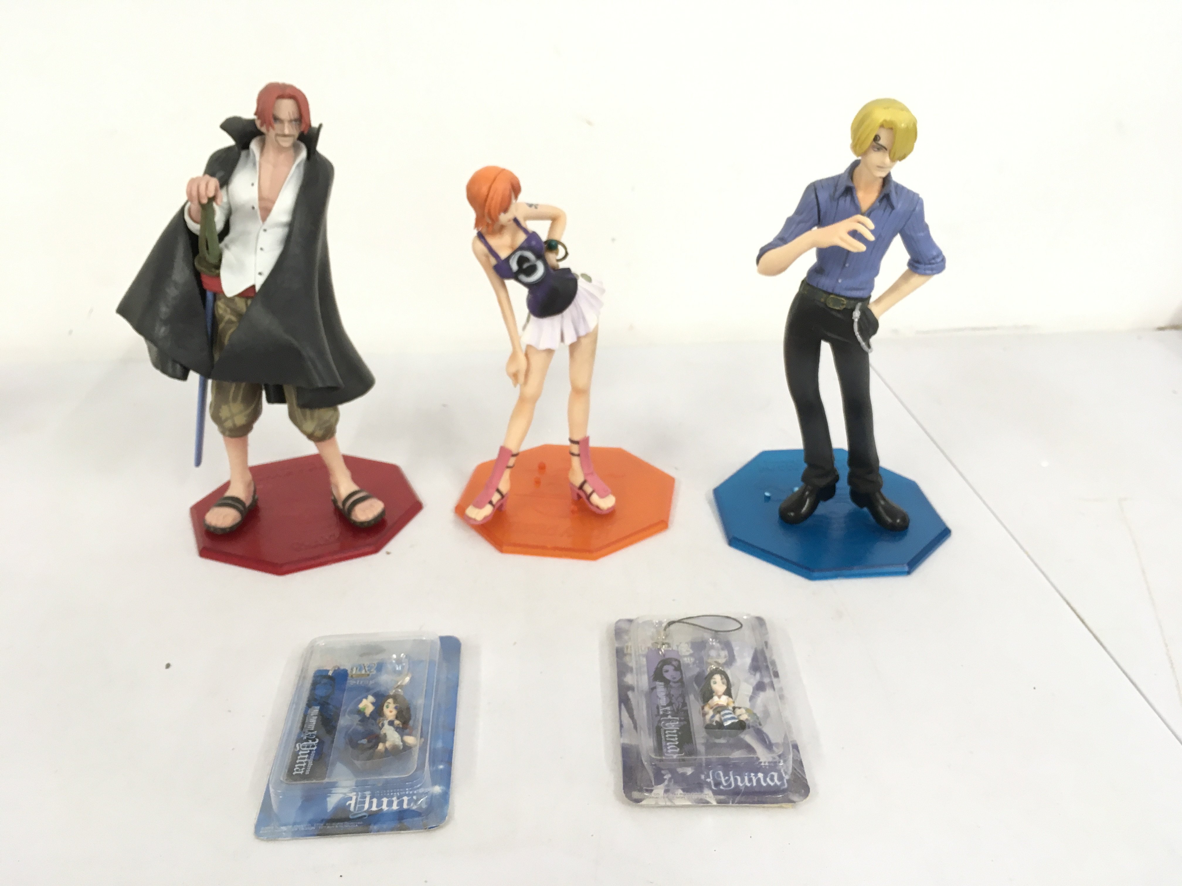 A Small Collection Of One Piece Anime Figures Including Shanks And Anime Figures. Plus 2 Final Fantasy X 2 Phone Straps.