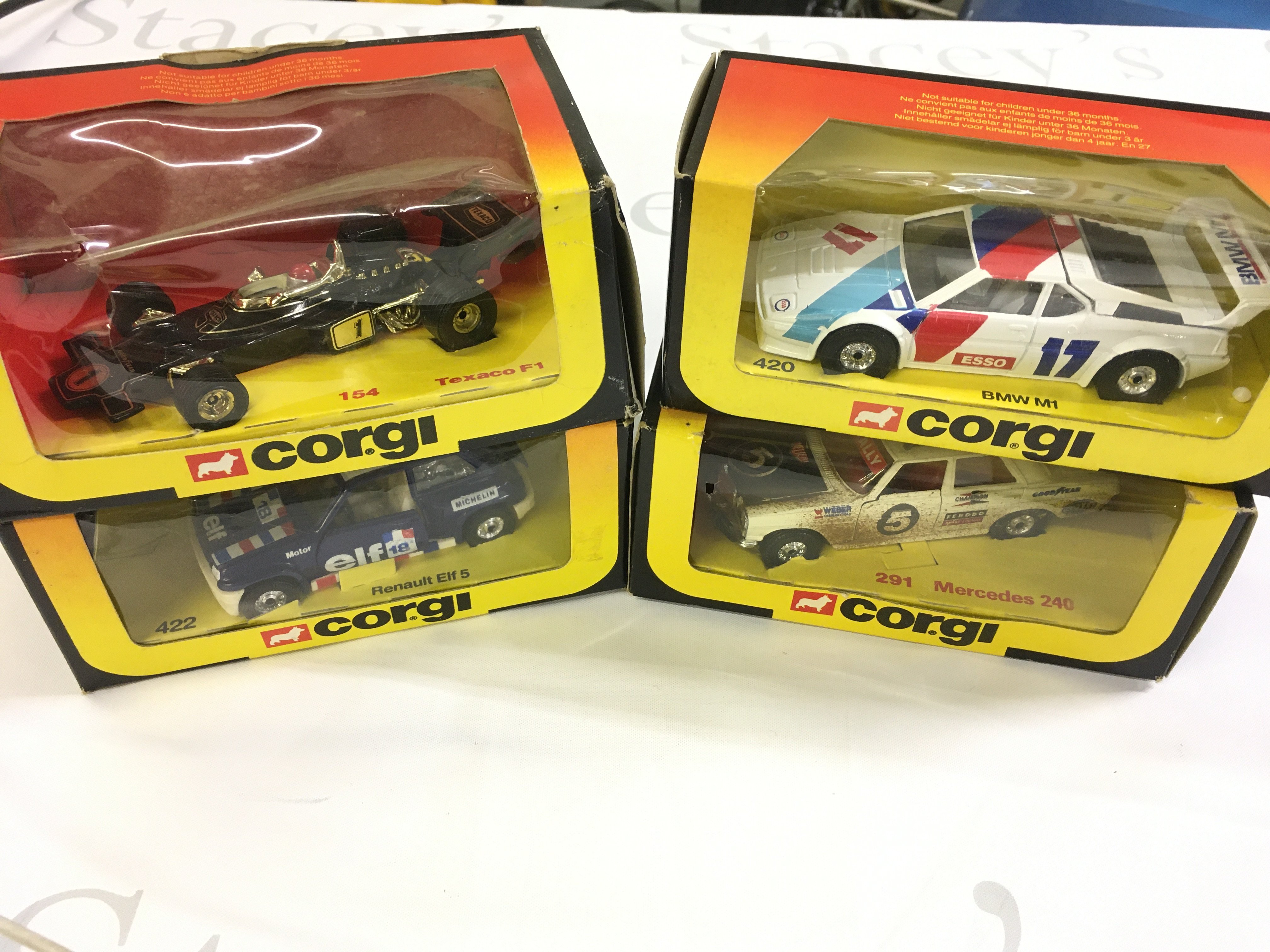 4 Boxed Corgi Diecast Including Texaco F1 #154. A Renault Elf 5 #422. A BMW M1 #420 And A Mercedes 240 #291.