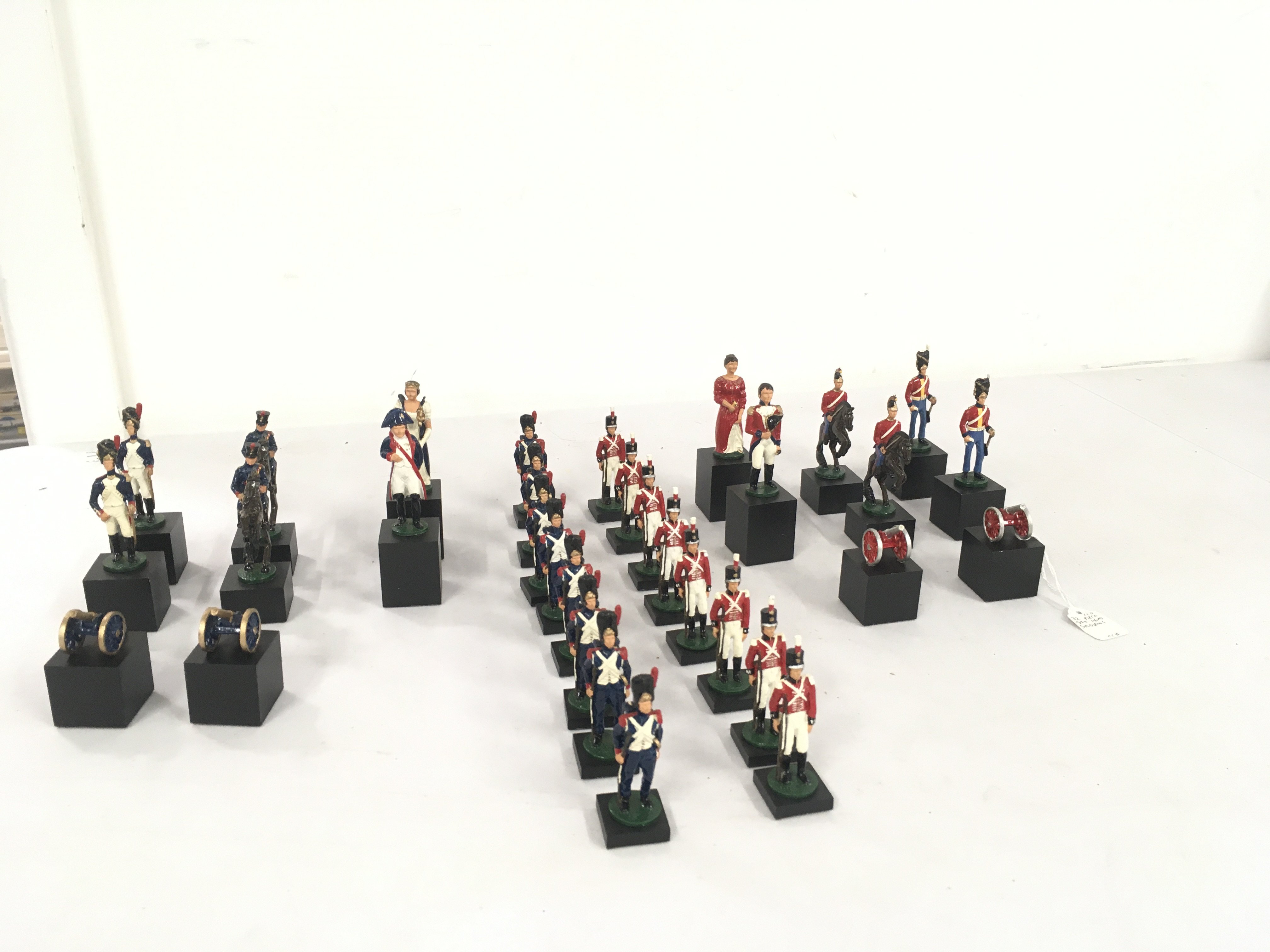 A set of painted lead soldiers from the Napoleonic war forming a set of Chess pieces. English side lead by Wellington and the French by Napoleon.No reserve