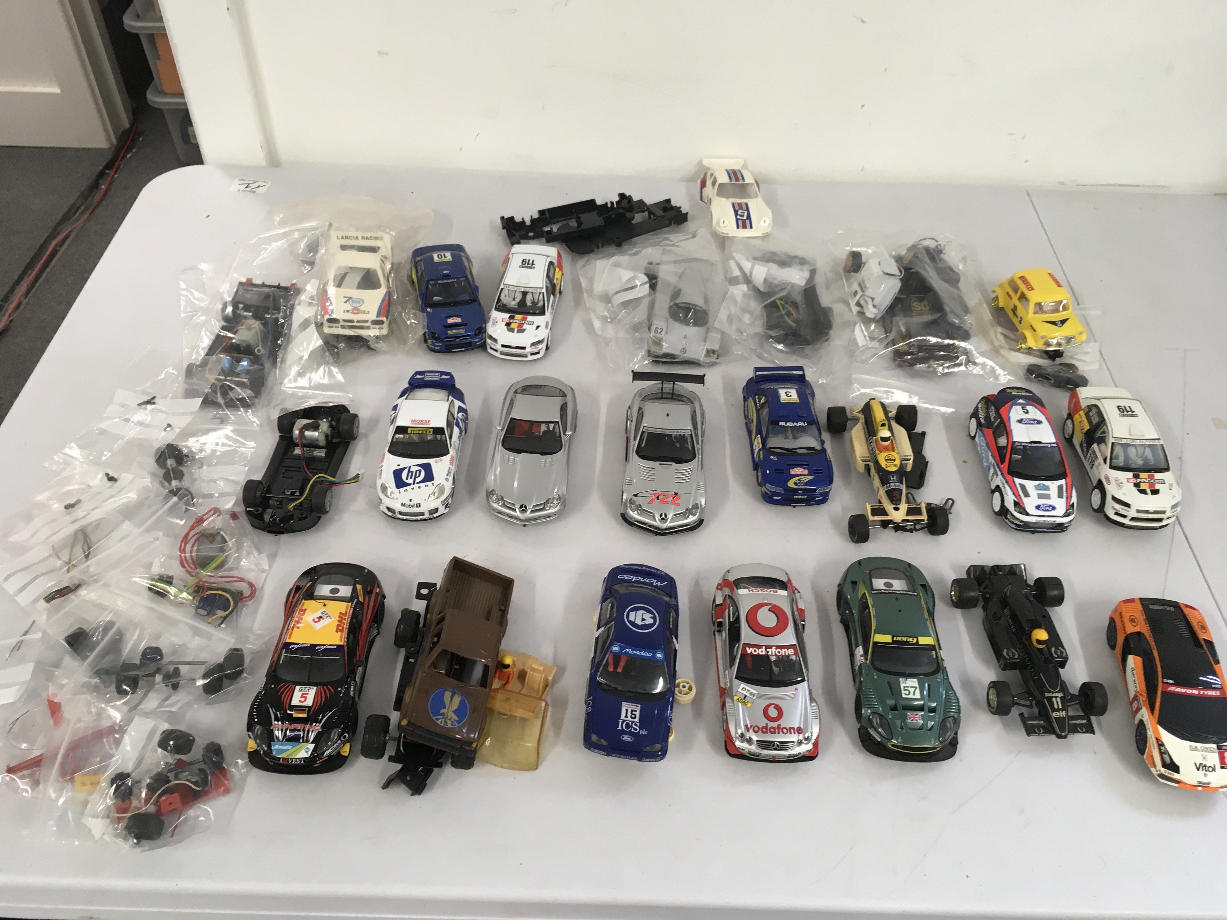 A collection of Scalextric..Hornby slot racing cars with spares and accessories. Spares or repairs. No reserve.
