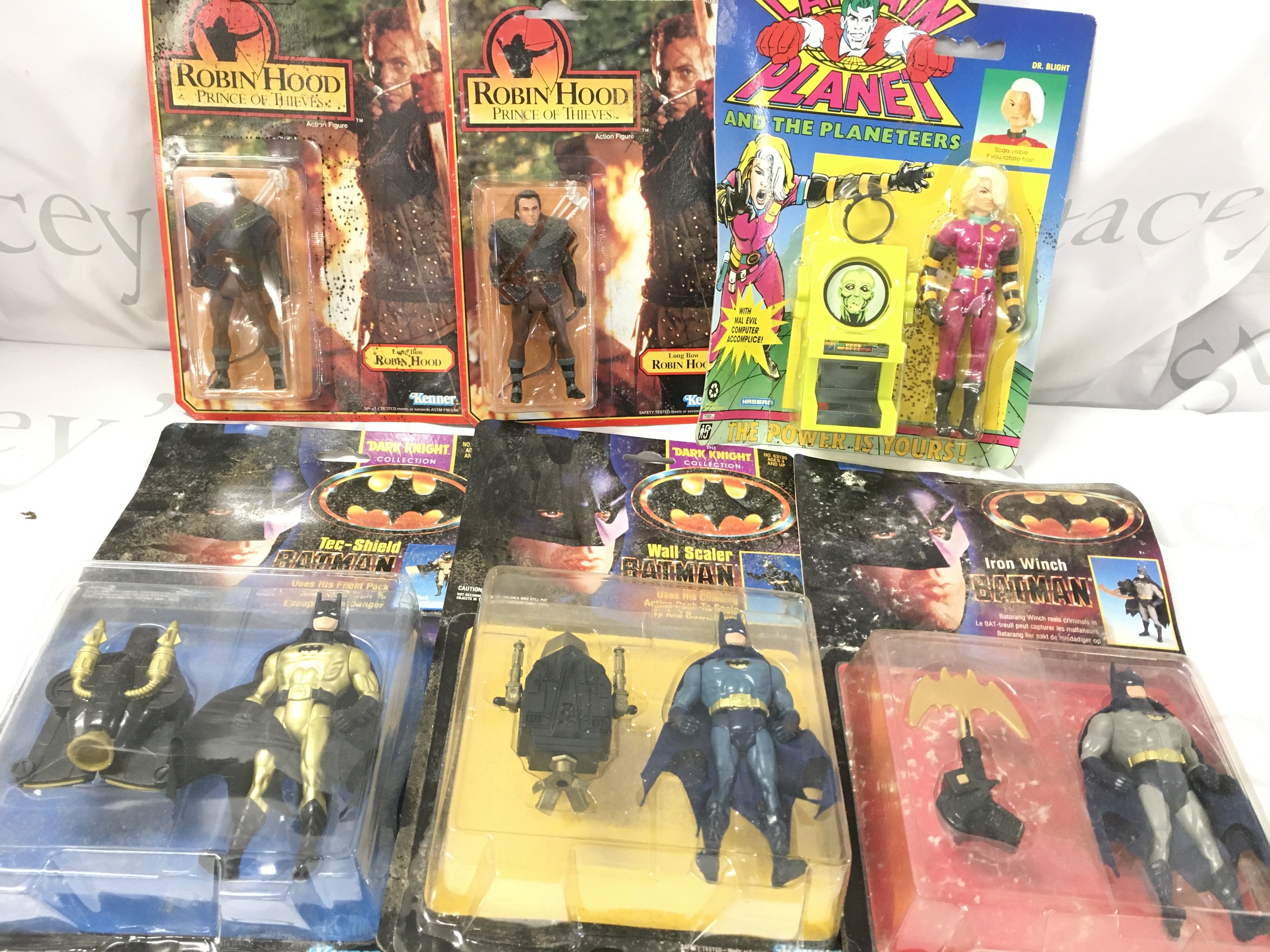 6 Assorted Carded Figures. Batman And Robin Hood. with Some Damp Damage.