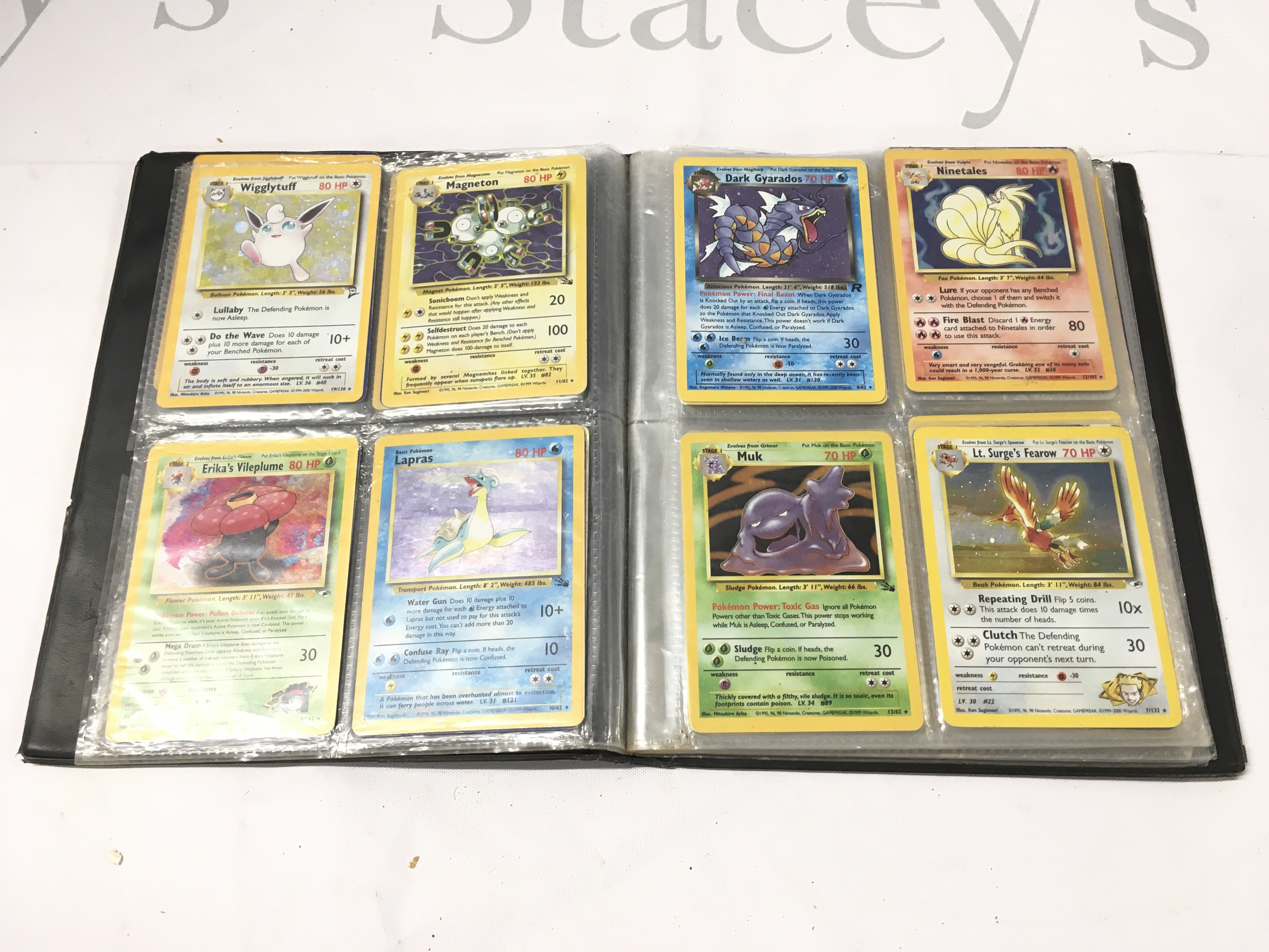 A Binder Containing A Small Collection Of Vintage Pokemon Cards.