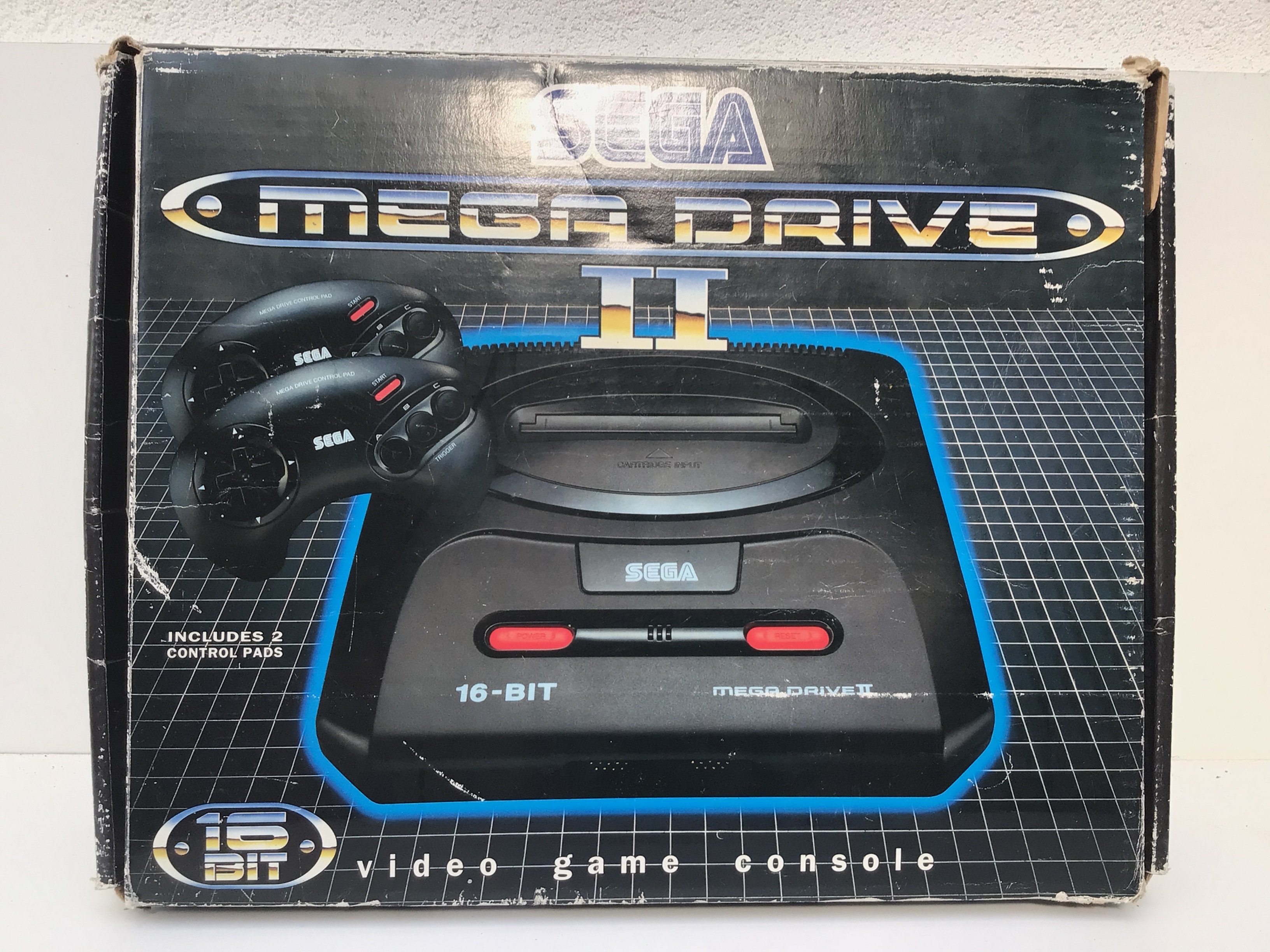 A boxed Sega Mega Drive 16 bit video games console. Includes 2 controllers and power supply. Also has 4 boxed games. Instructions included.