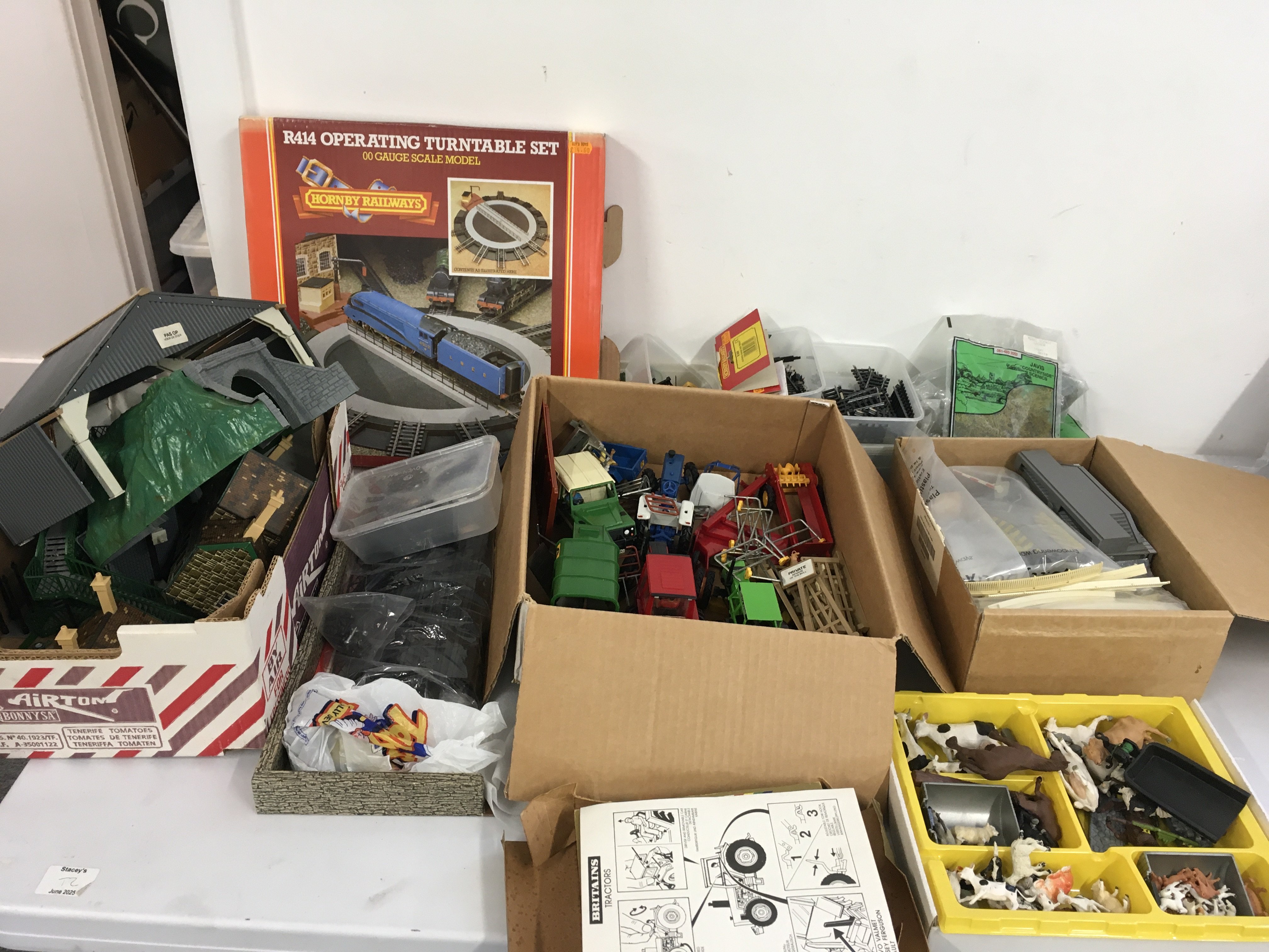 A mixed collection of Hornby 00gauge model railway accessories including track ..buildings..scenery etc. plus a collection of Britains tractors..farm machinery and animals.