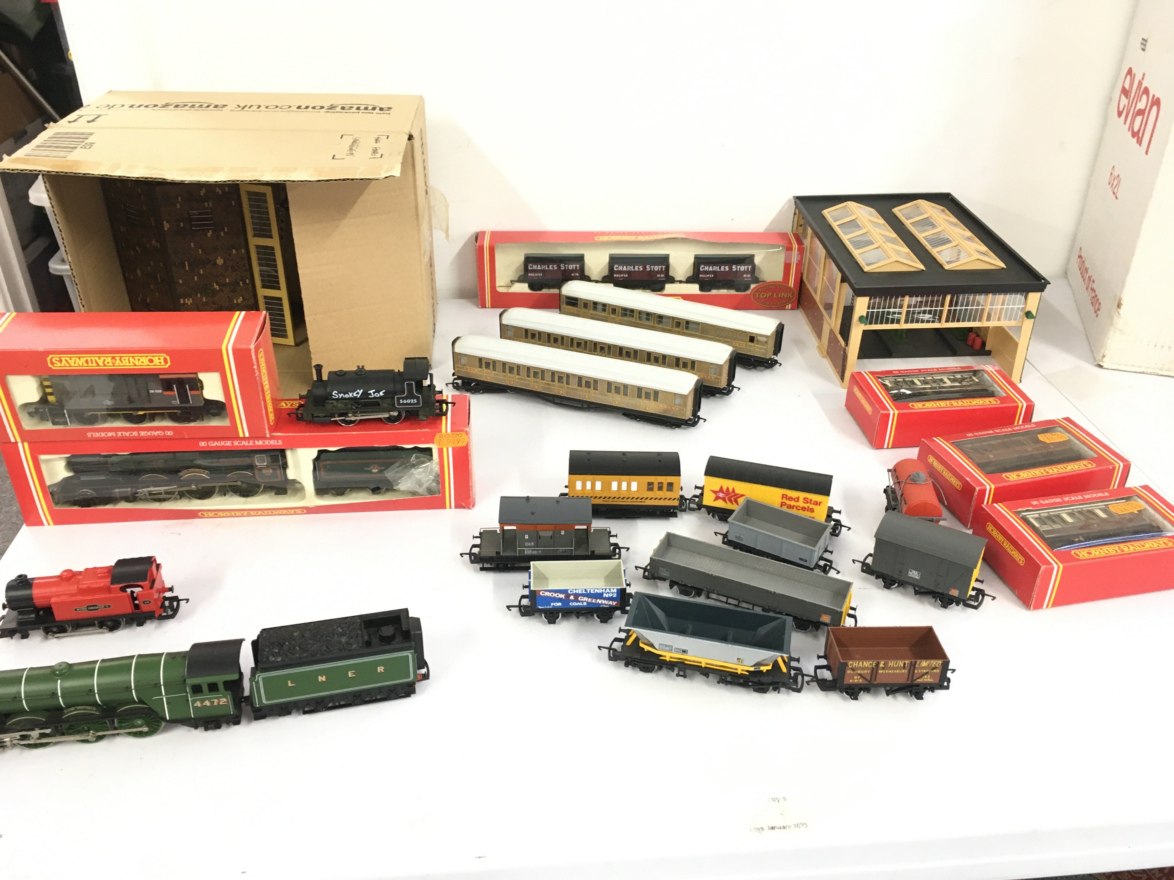A Collection of 00gauge model railway including locomotives..coaches and wagons by Hornby etc. also includes some buildings.