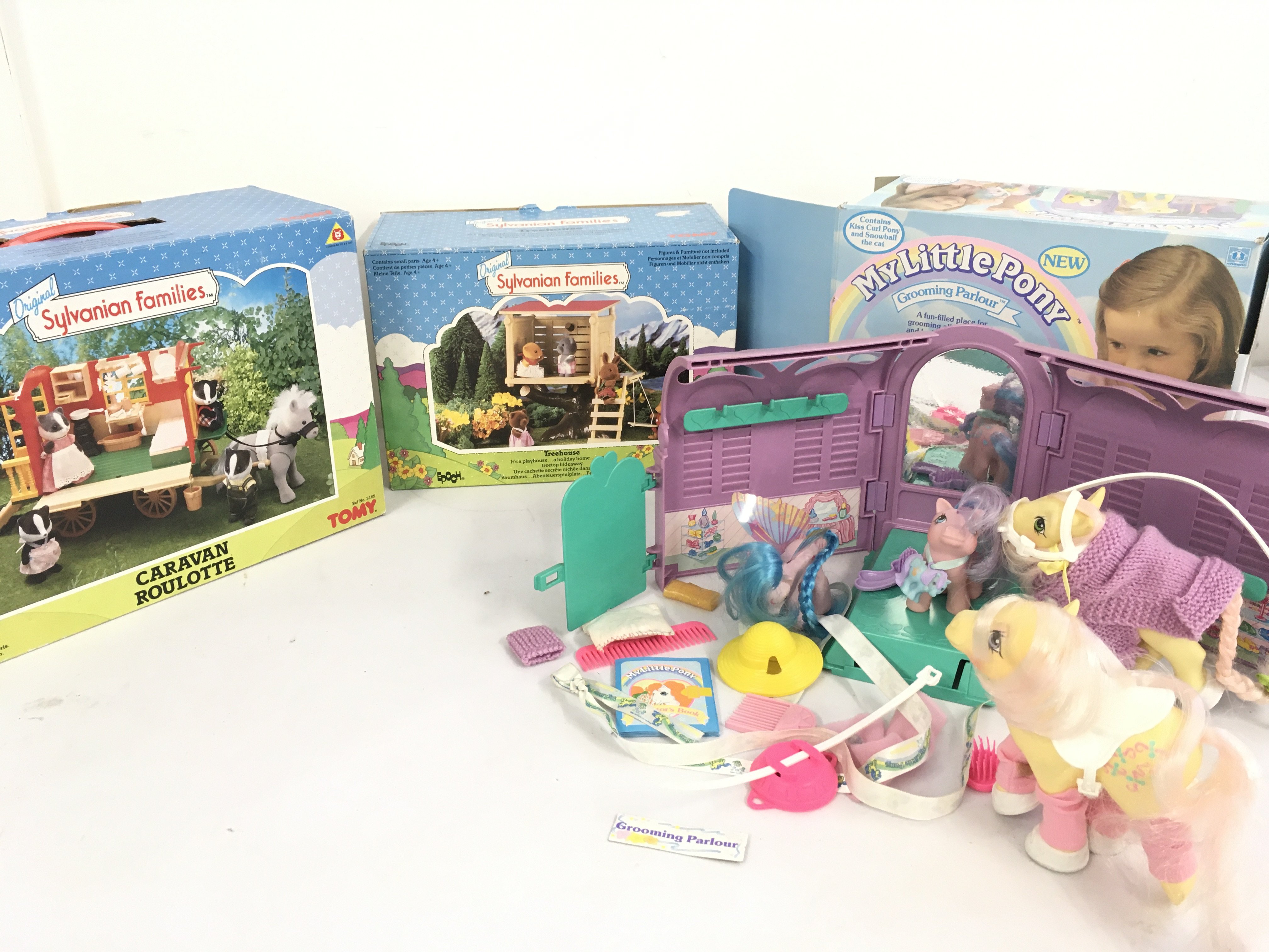 A collection of boxed Sylvanian Families featuring a Caravan Roulotte and a Treehouse by Tomy. Also boxed My Little Pony &hellip;Grooming Parlour with 4 ponies. No reserve