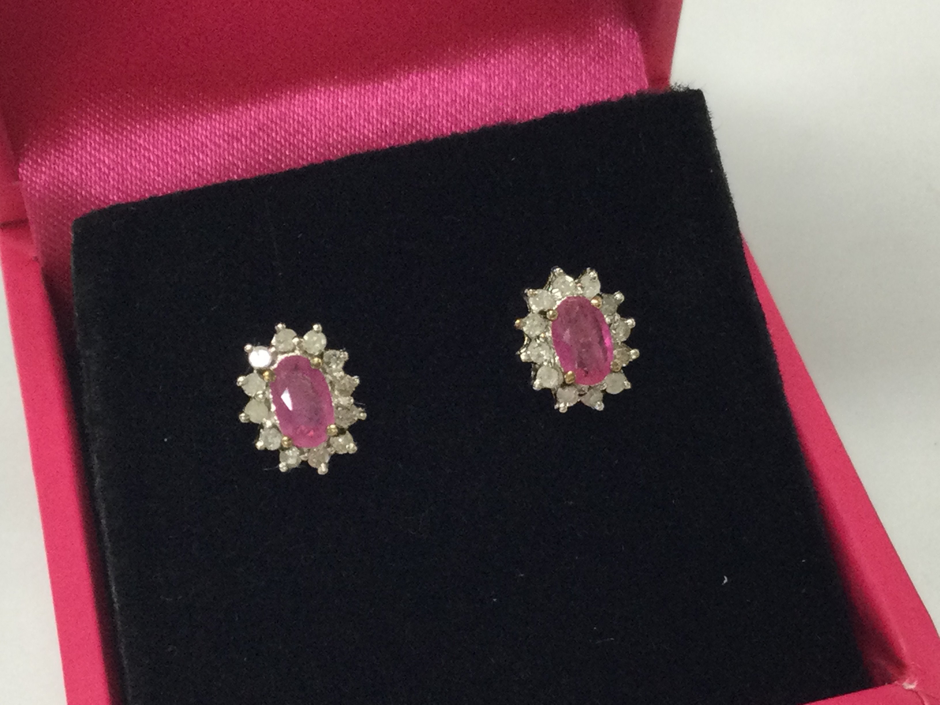 A pair of 9ct gold diamond and ruby earrings. Postage B