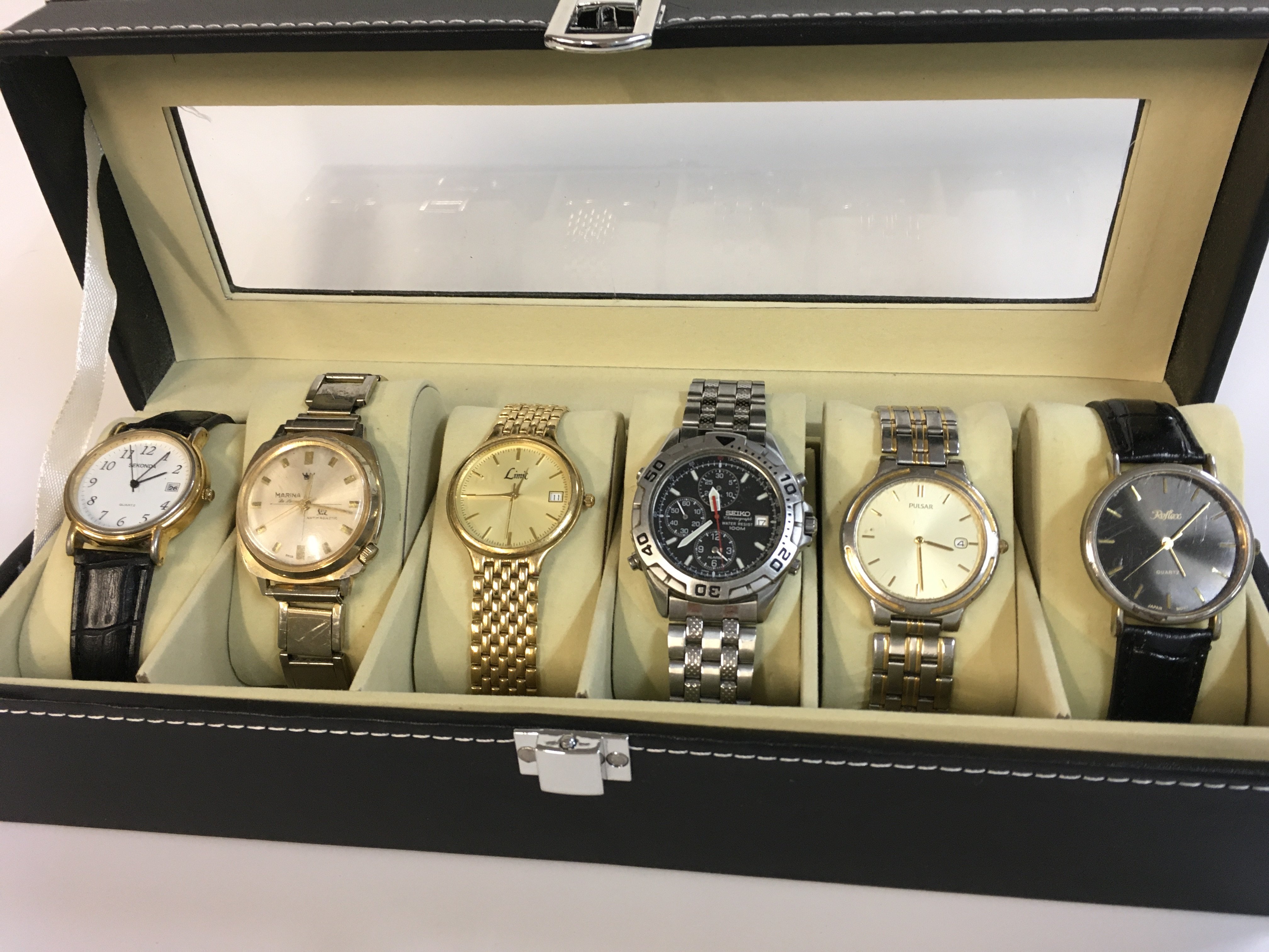 Six vintage mens watches in a display case including Sekonda, Marina, Limit, Seiko, Pulsar, Reflex