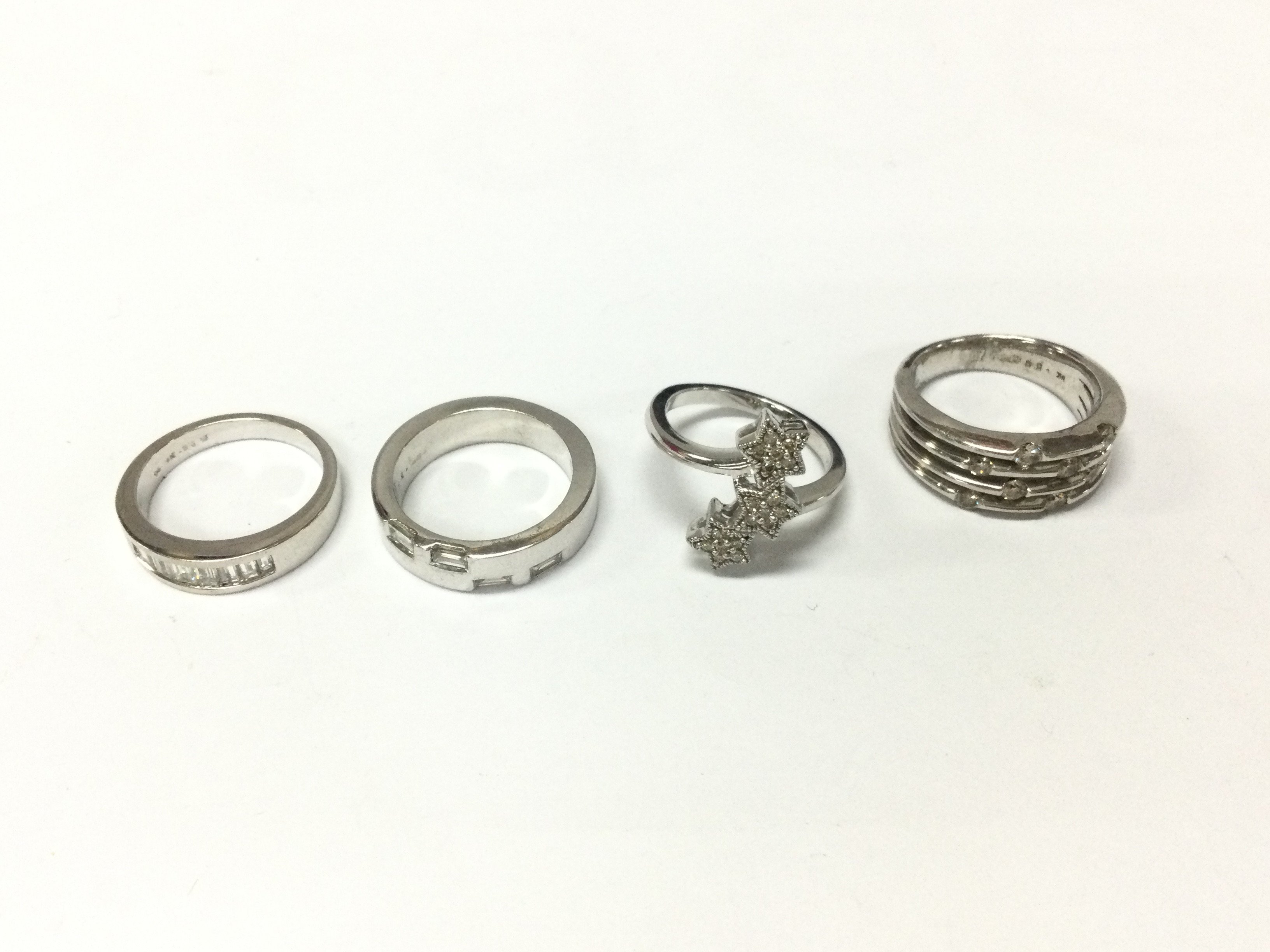 Four 9ct white gold diamond rings of various designs. 24.33g total. Sized M 1/2 to N Postage B
