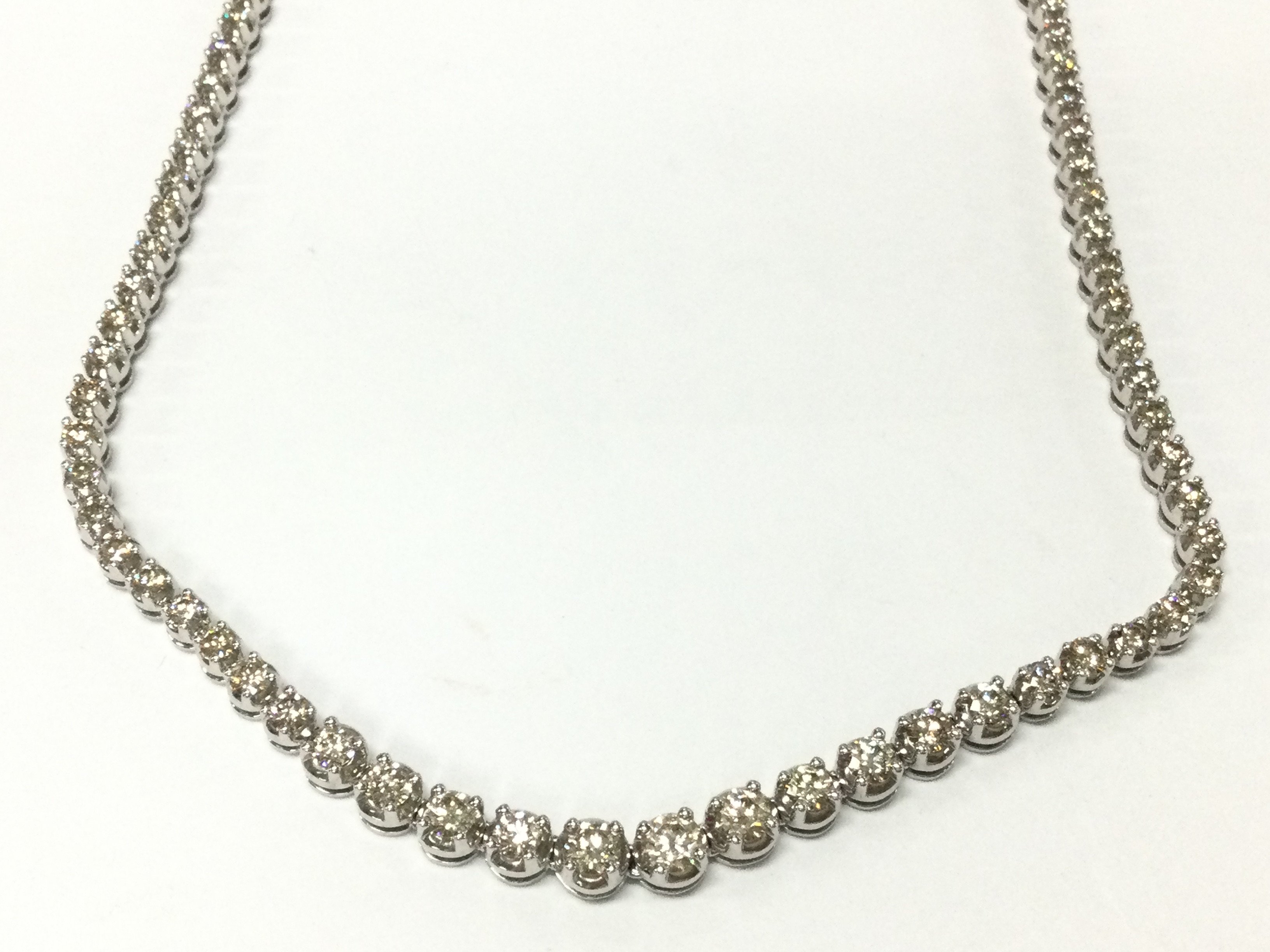 A 9ct white gold diamond graduated necklace set with approximately 10.40ct total. 43cm length. Postage B