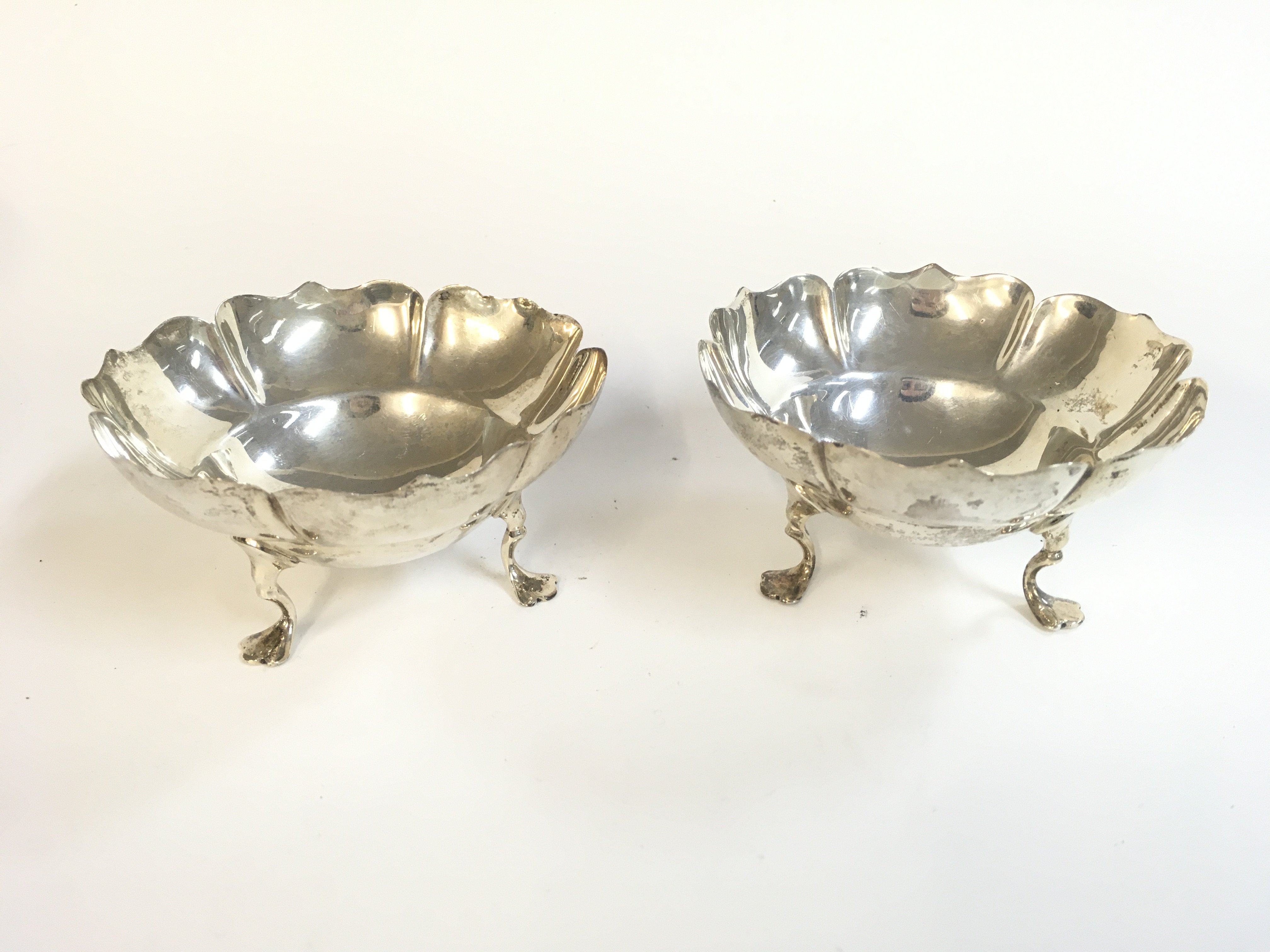 A pair of small silver dishes. 5cm tall, 9cm wide. Postage category A