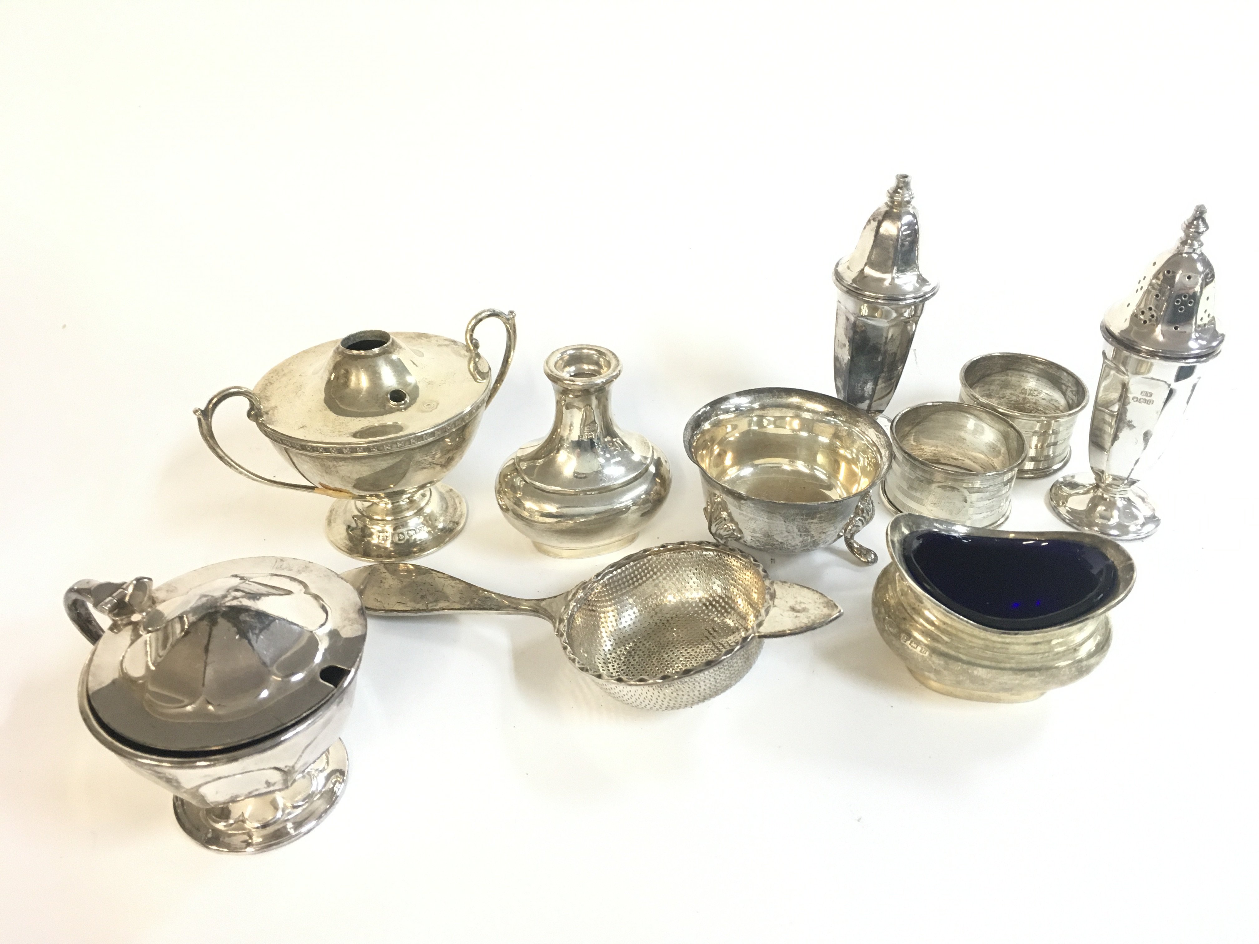 A Collection of cruets, napkin rings , sugar sifter etc. postage category B