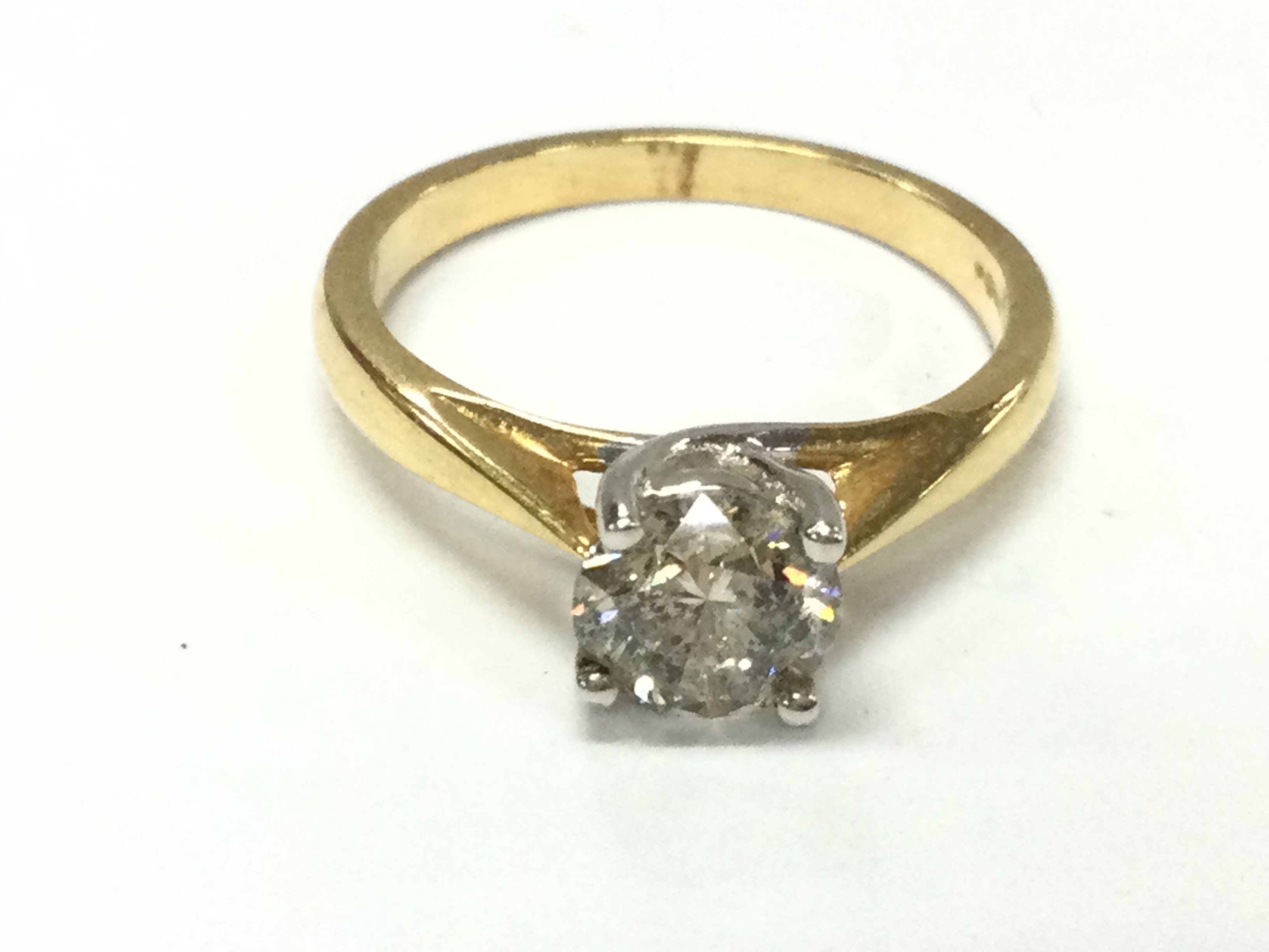 An 18ct gold diamond solitaire ring. Approximately 1.1ct diamond (heavy inclusion) size N and 3.4g