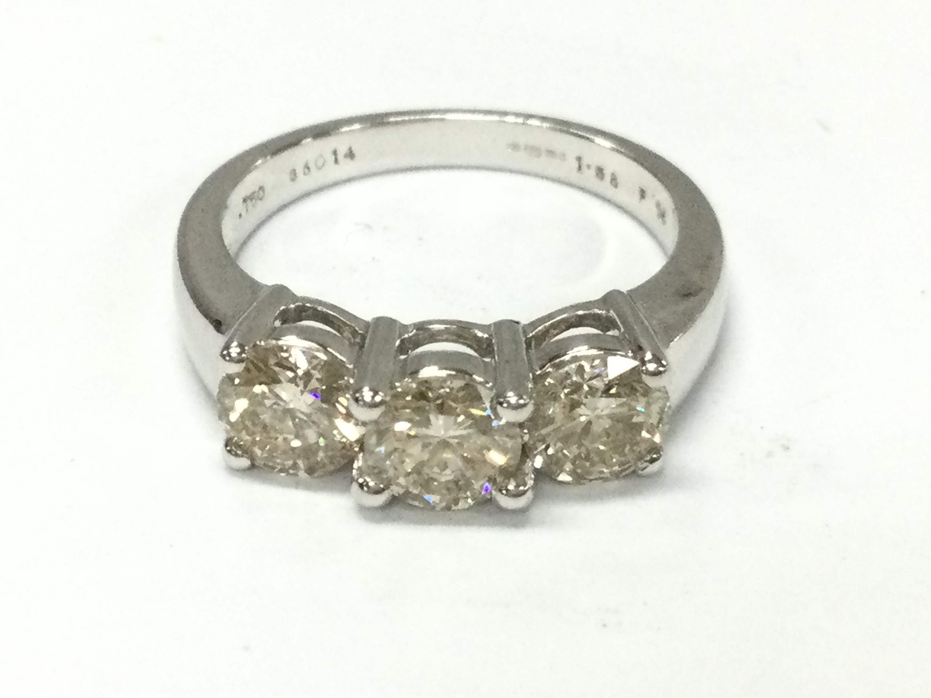 An 18ct white gold three stone diamond ring with approximately 1.5ct and 5.1g and size N