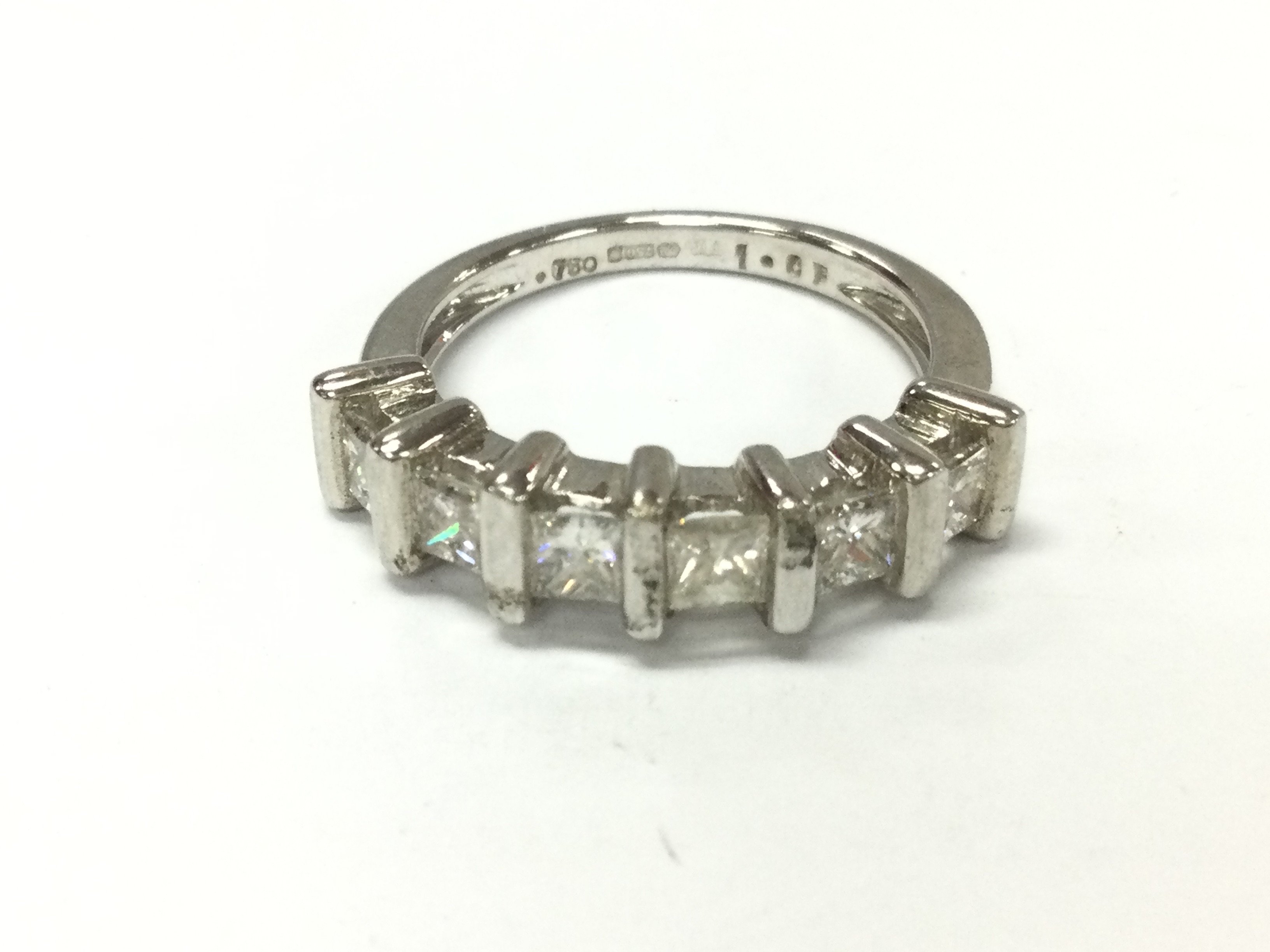 An 18ct white gold 6 stone princess cut ring. Approximately 1ct total and size N 5g