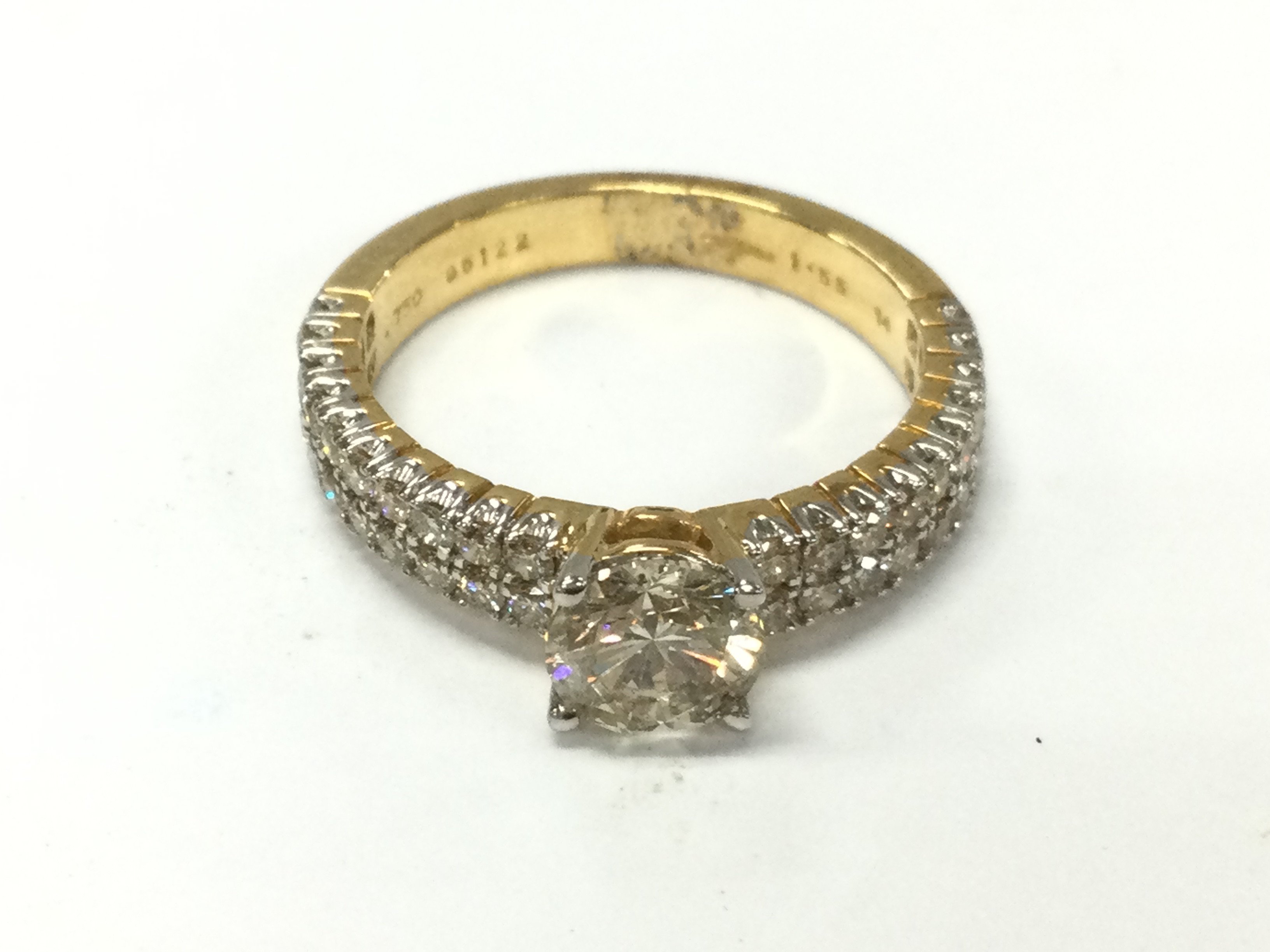 An 18ct gold diamond solitaire ring with diamond shoulders. Approx 1.55ct total and Size N 4.5g