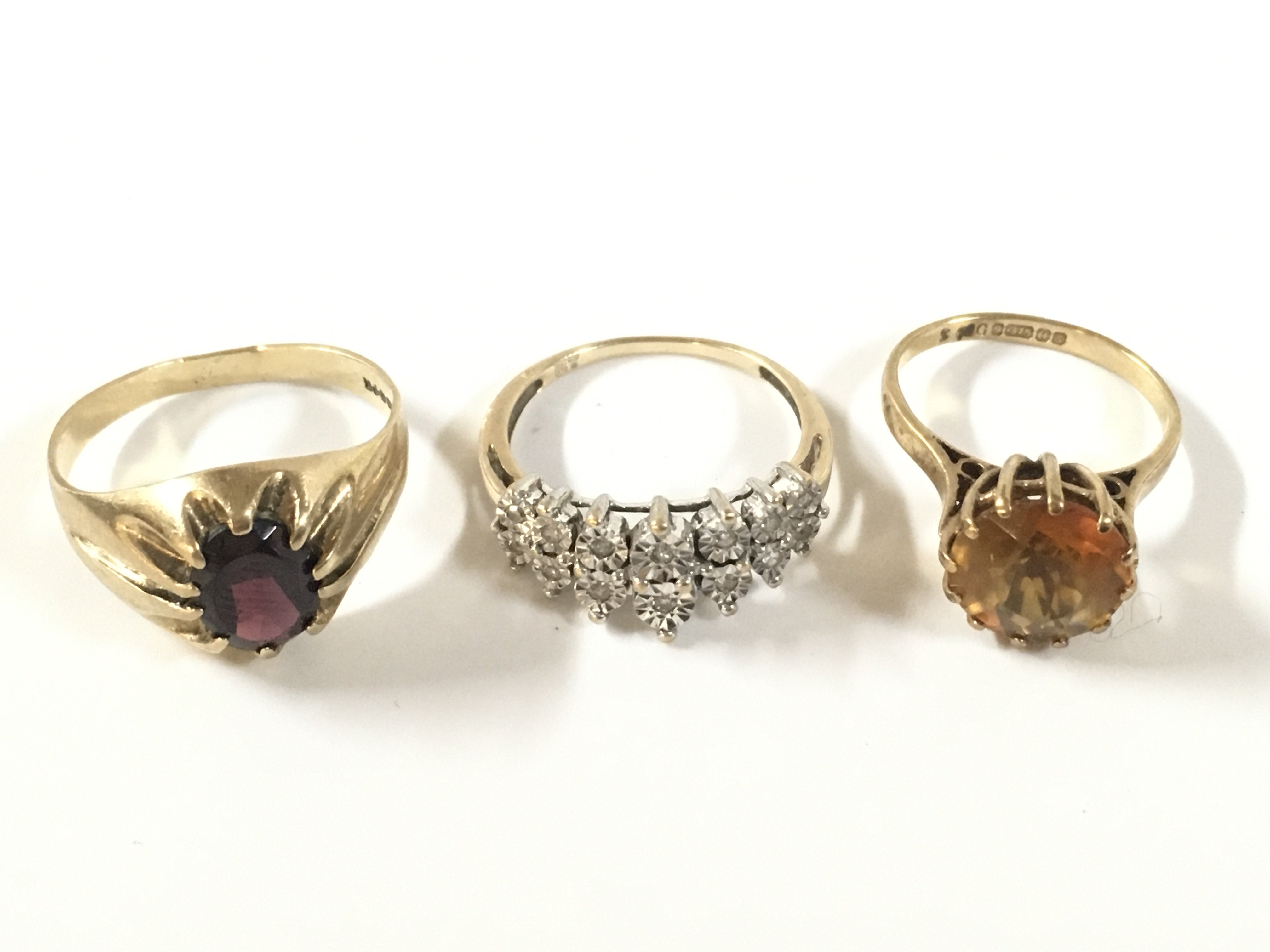 Three 9ct gold stone set rings. Approx weight 8.62 grams.