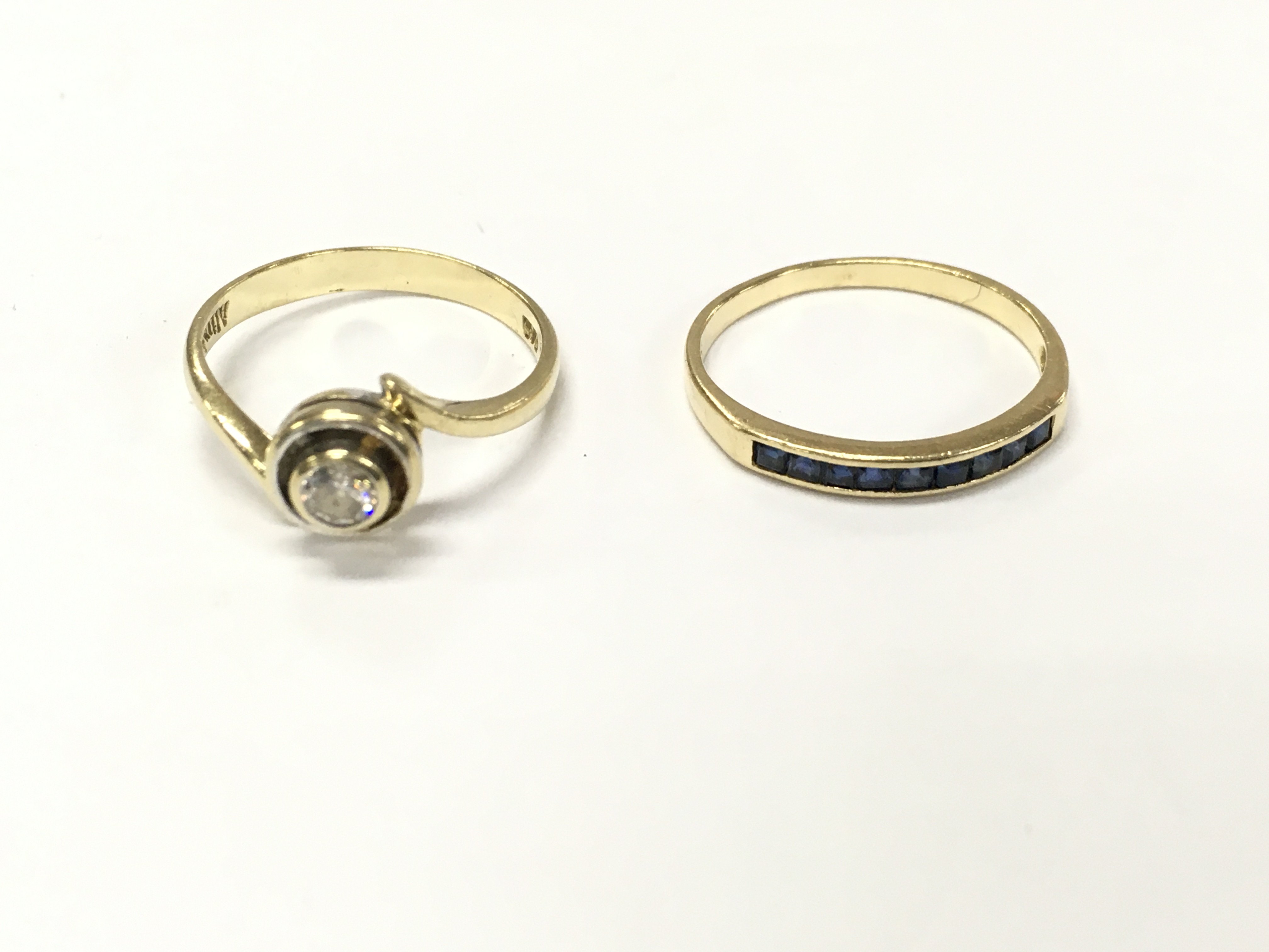 A 14ct gold diamond solitaire ring size O and a 14ct sapphire 1/2 hoop ring size N 3.86g total.