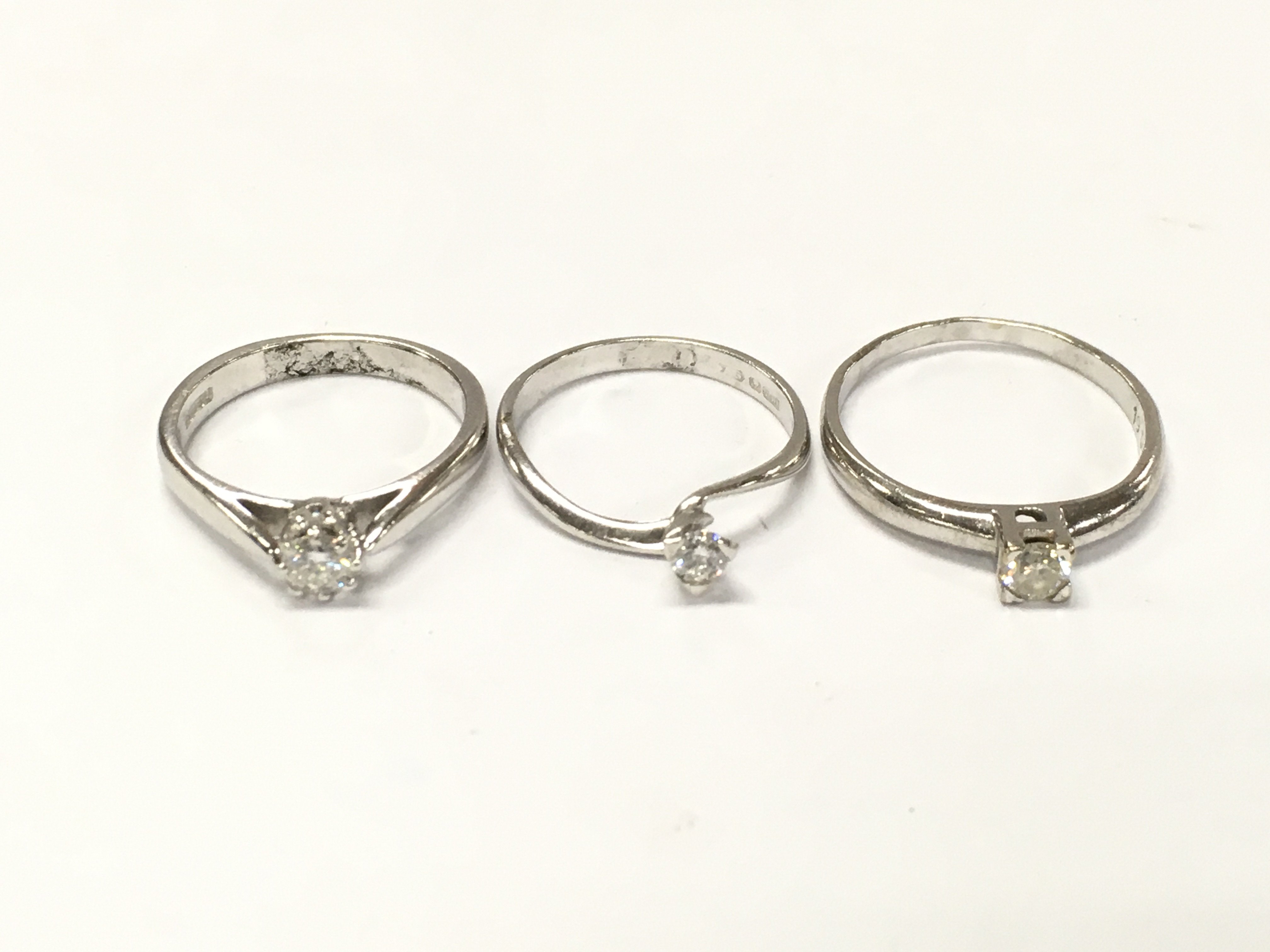 Three 18ct white gold diamond solitaire rings sizes I 1/2 and N approximately 7.10g