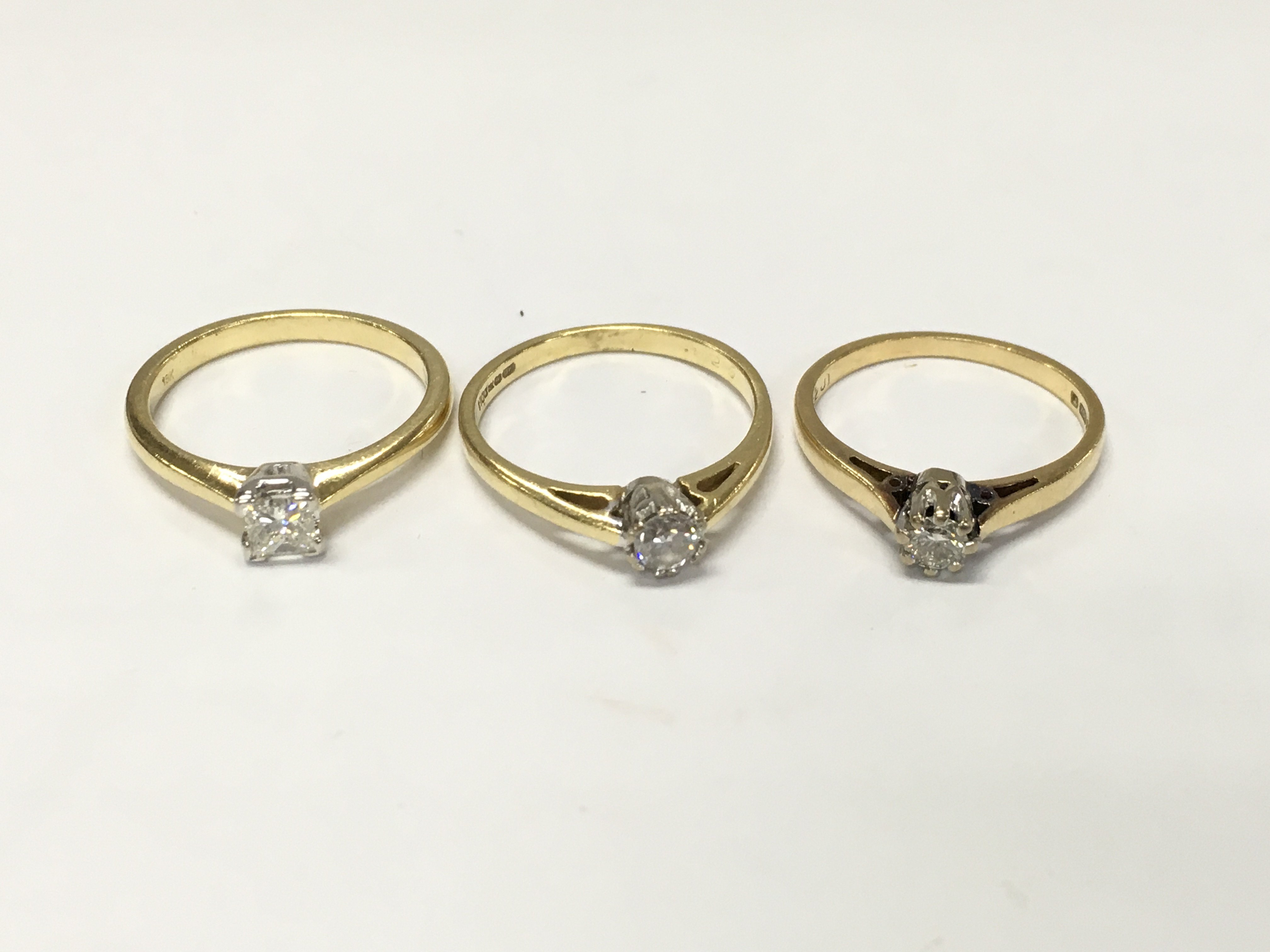 Three 18ct gold diamond solitaire rings. Sizes L and N approximately 8.4g