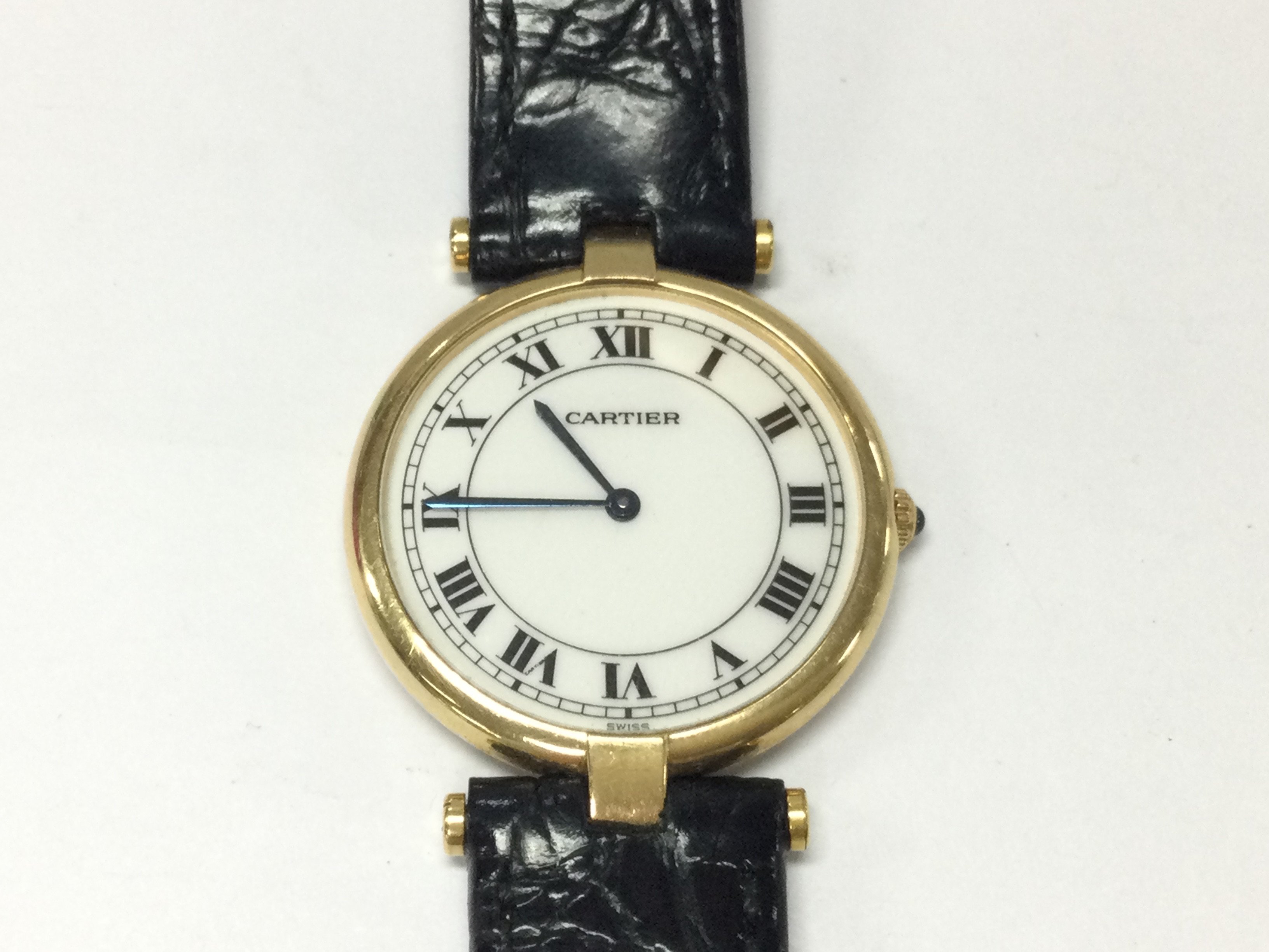 An 18ct Cartier Panthere vendome watch with black leather strap. Quartz movement seen running. Postage A