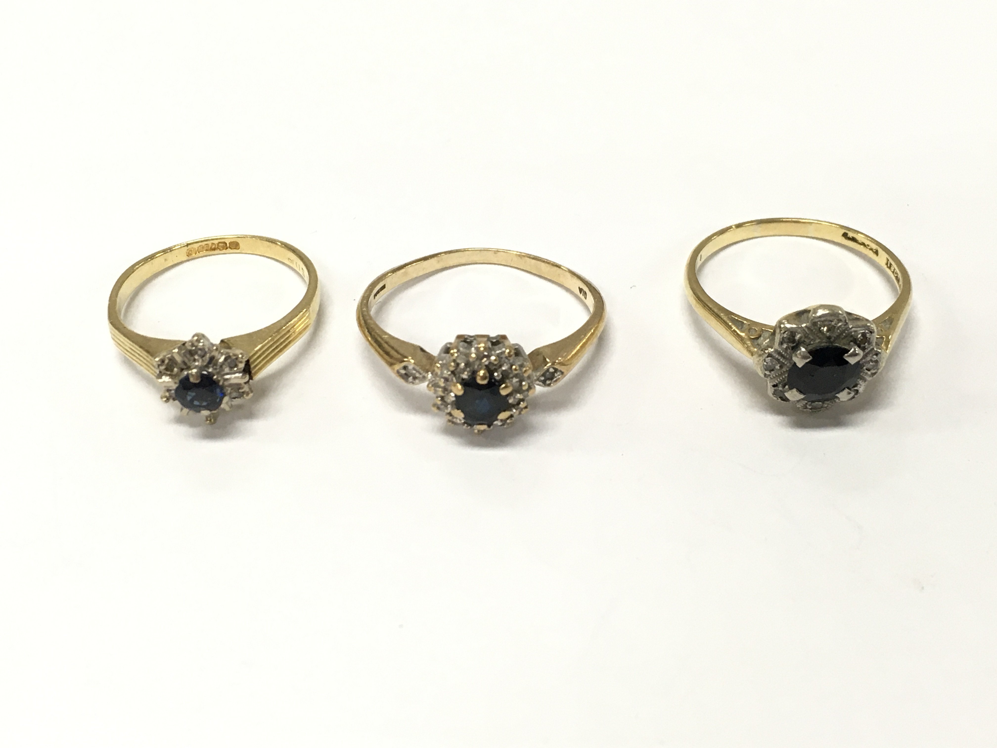 Three 18ct gold sapphire and diamond cluster rings. Sizes K M and N approximately 7.9g