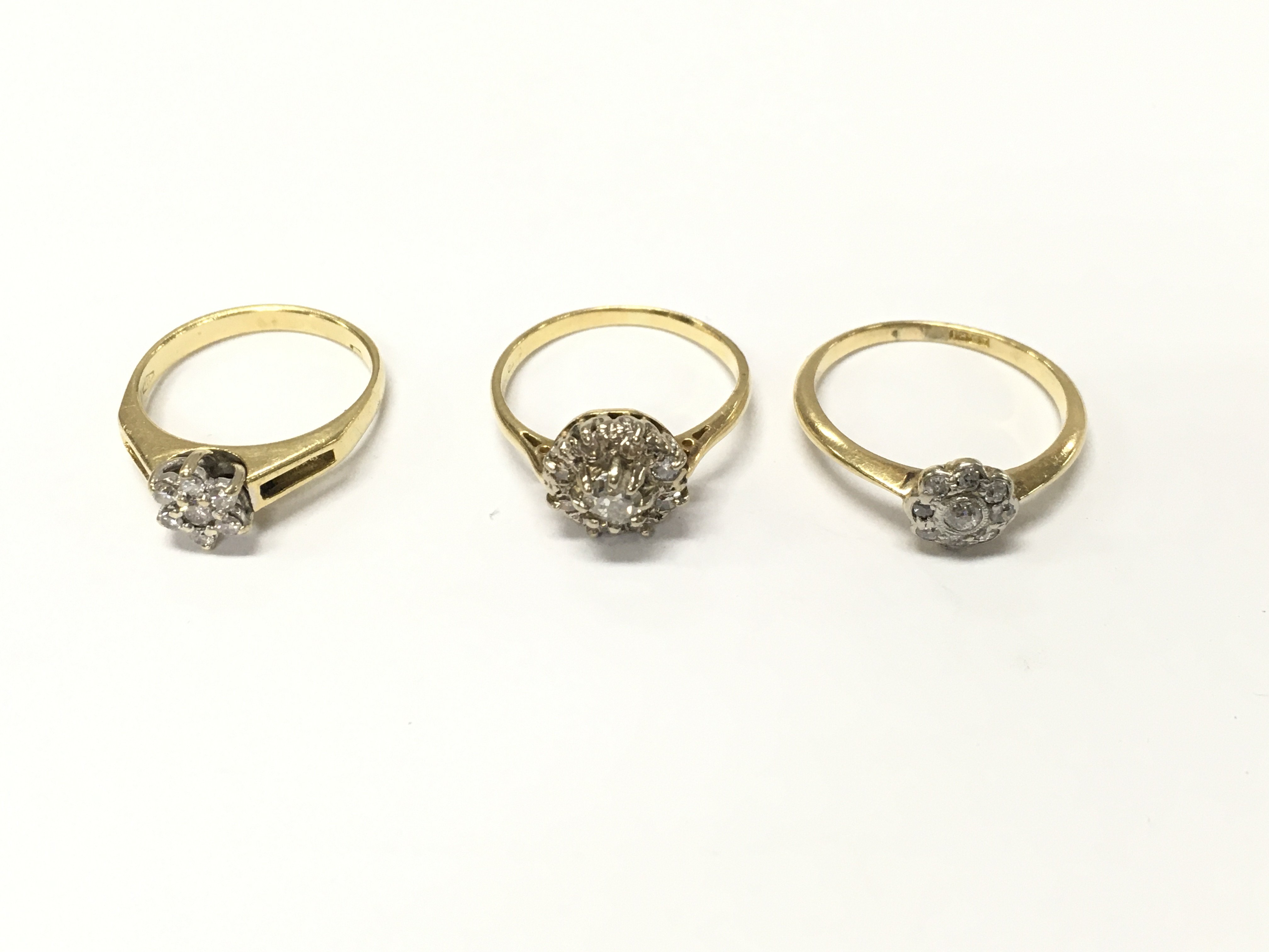 Three 18ct gold diamond cluster rings. Sizes J L and L 1/2 approximately 8.10g