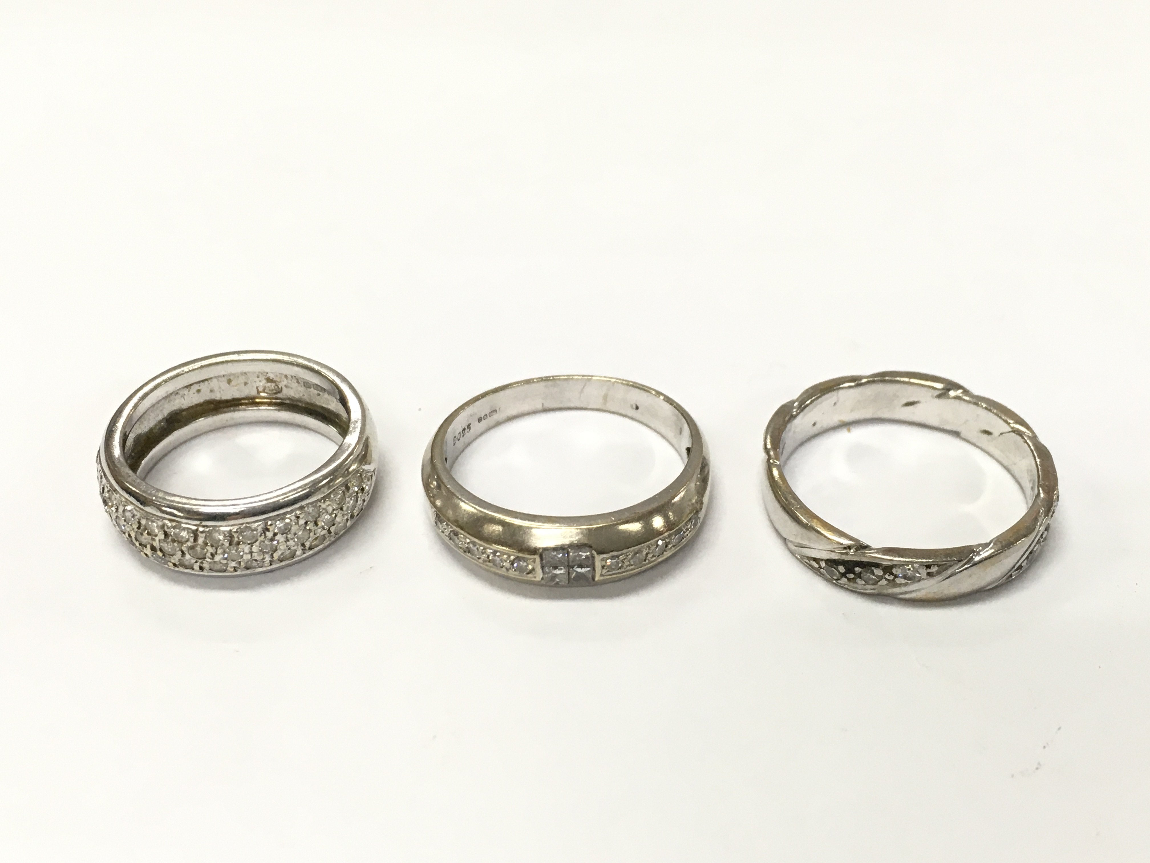 Three 18ct white gold diamond band rings sizes K 1/2 L and O approximately 8.4g