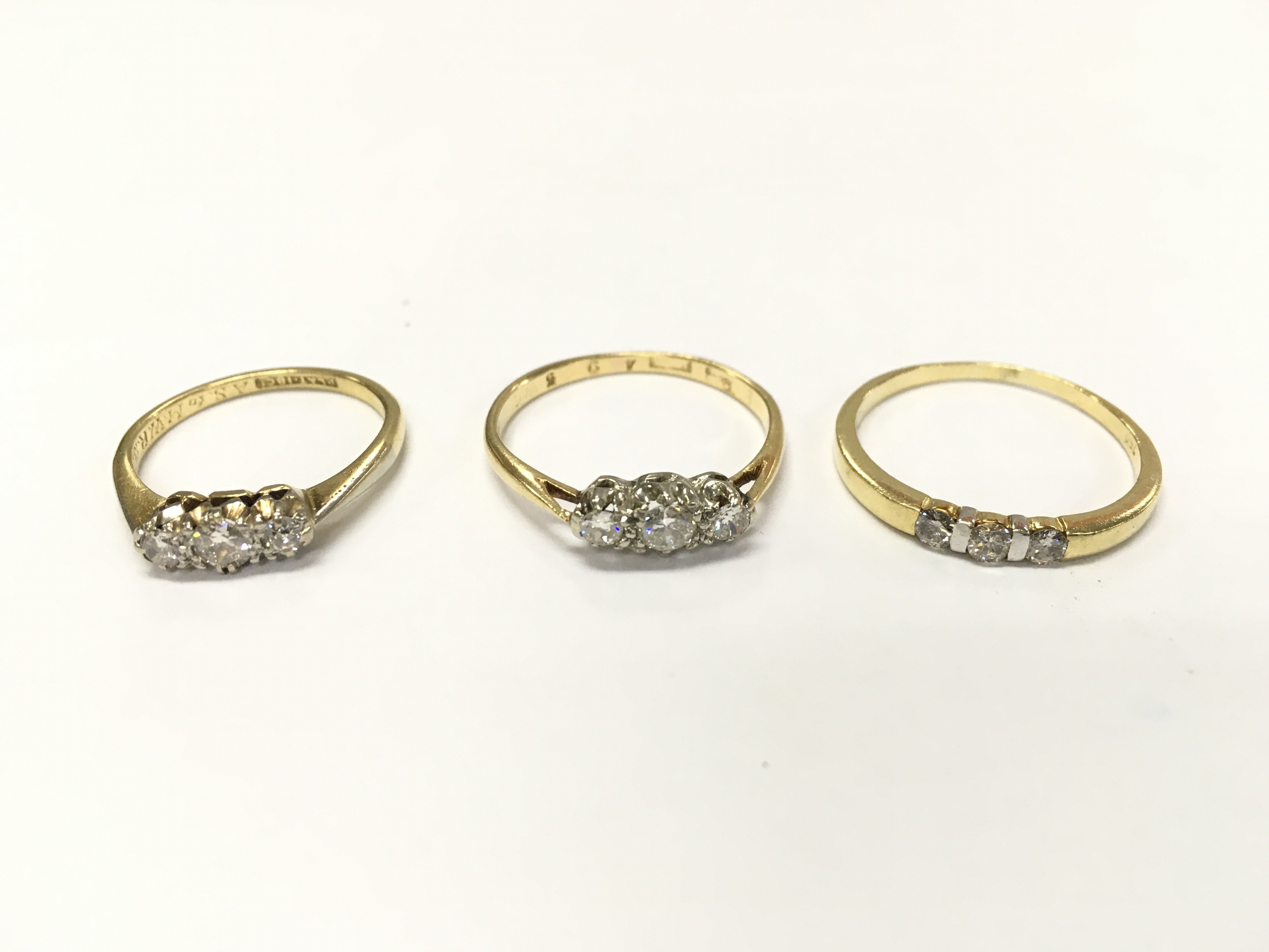 Three 18ct gold diamond three stone rings sizes L and P approximately 7g