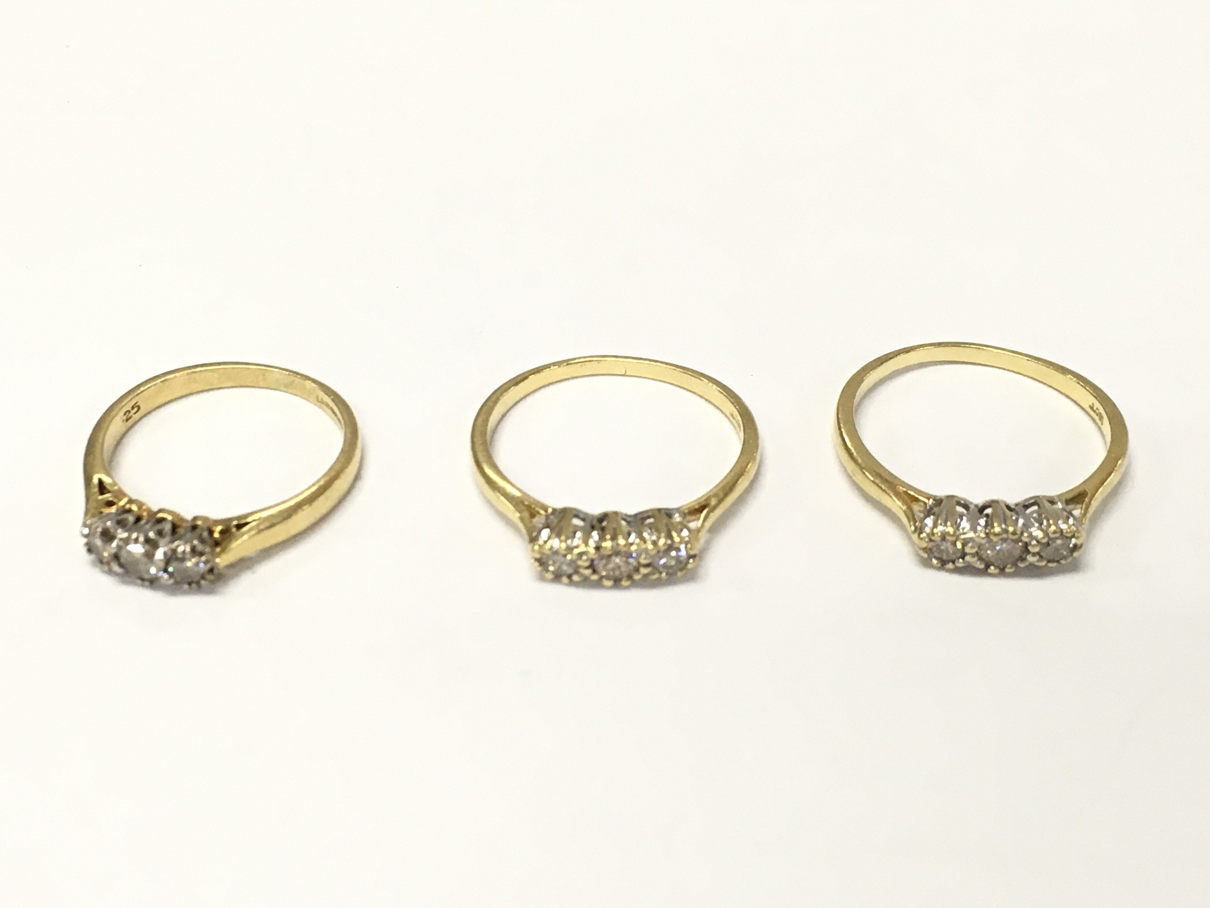 Three 18ct gold diamond three stone rings sizes K and M approximately 7.14g