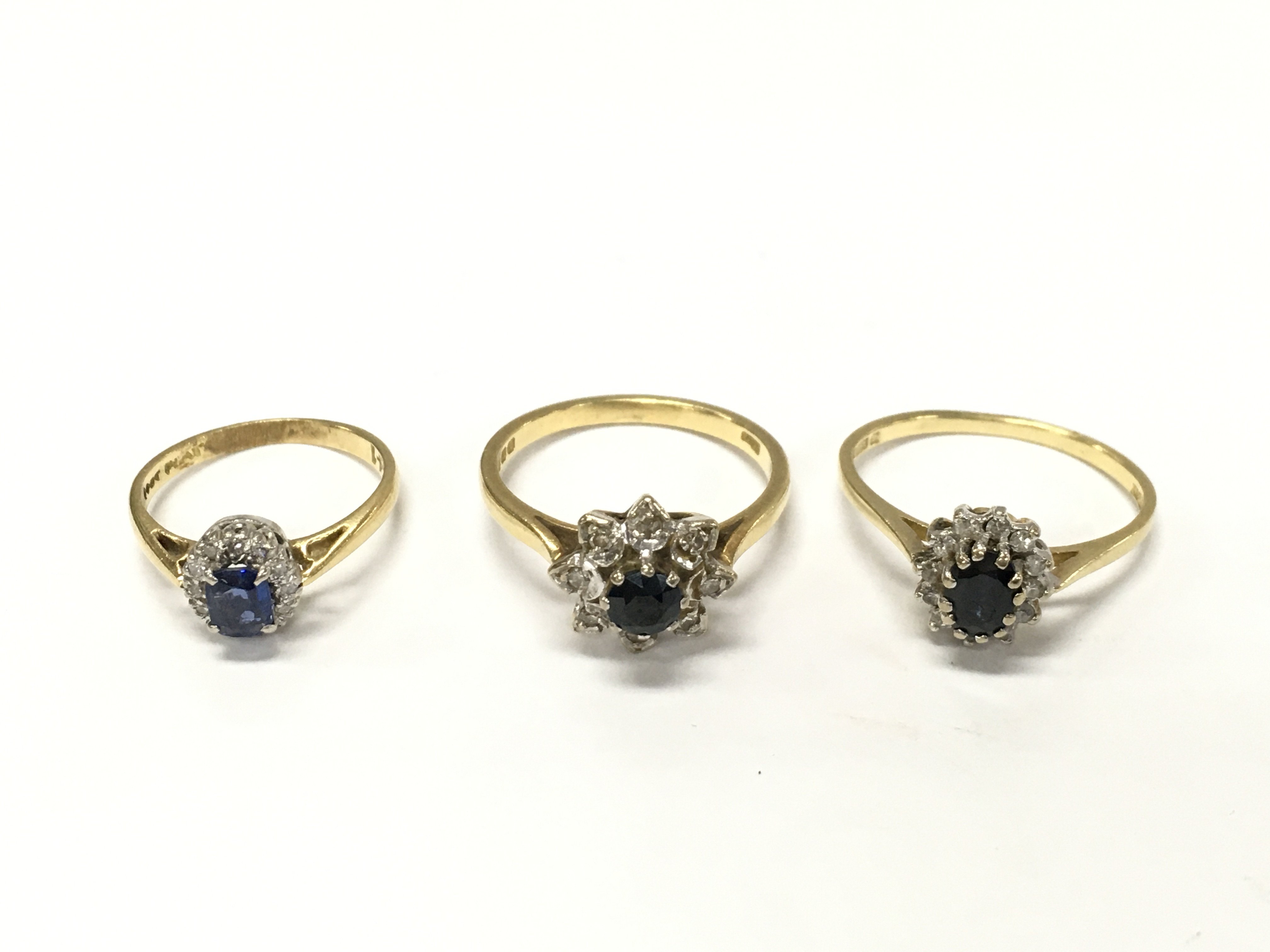 Three 18ct gold diamond and sapphire cluster rings sizesG 1/2 K N approximately 8.5g