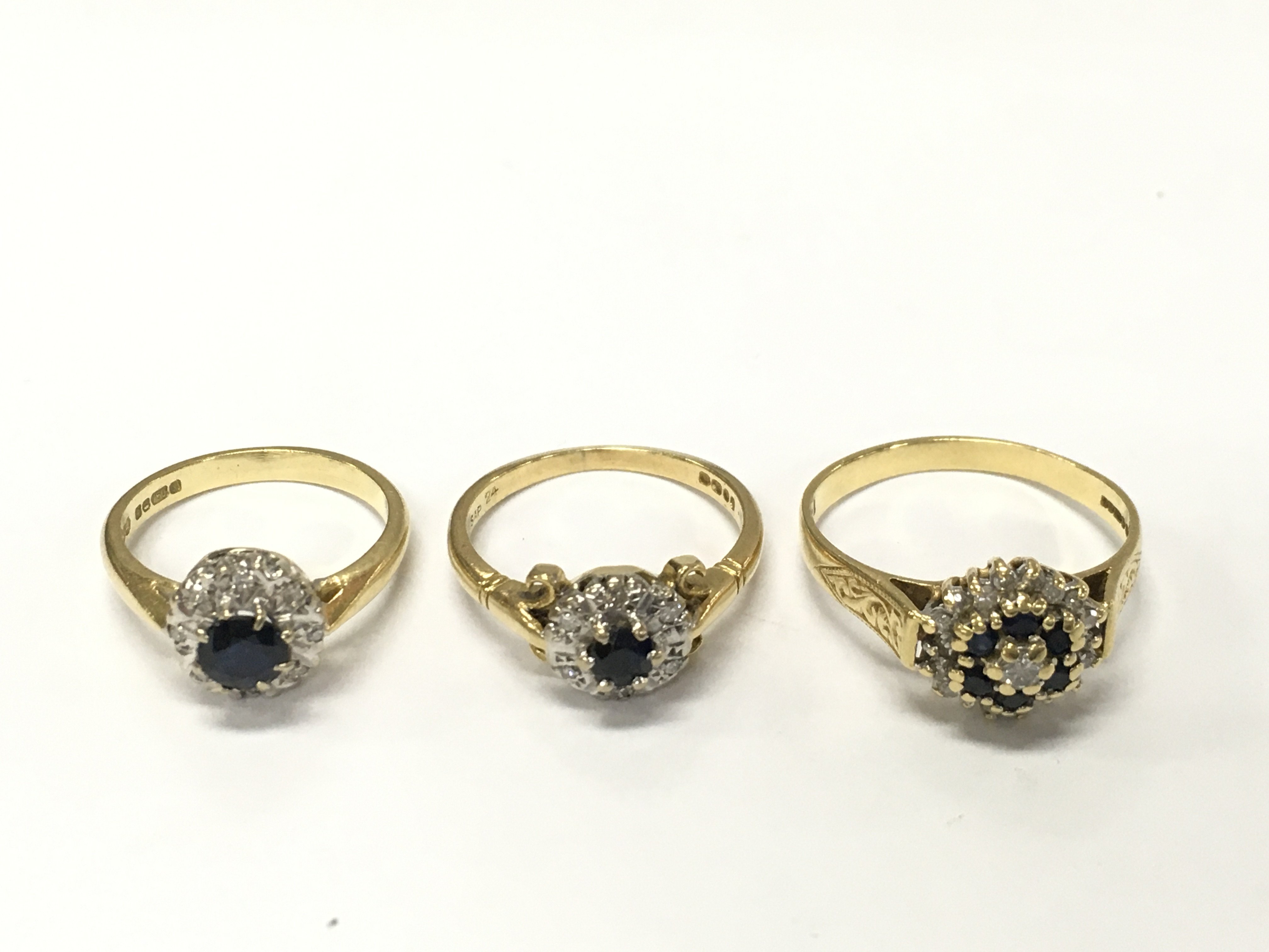 Three 18ct gold diamond and sapphire cluster rings sizes J L P approximately 10g