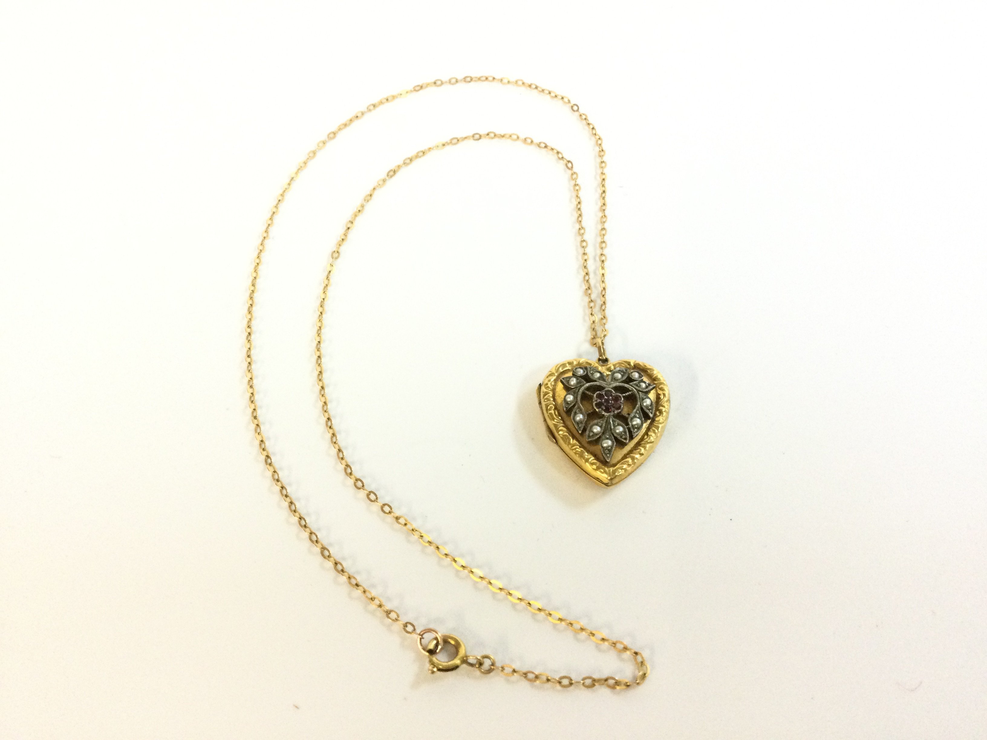 A 9ct back front silver fitting Heart pendant on a 9ct gold chain . 5.8g total weight. Postage category A