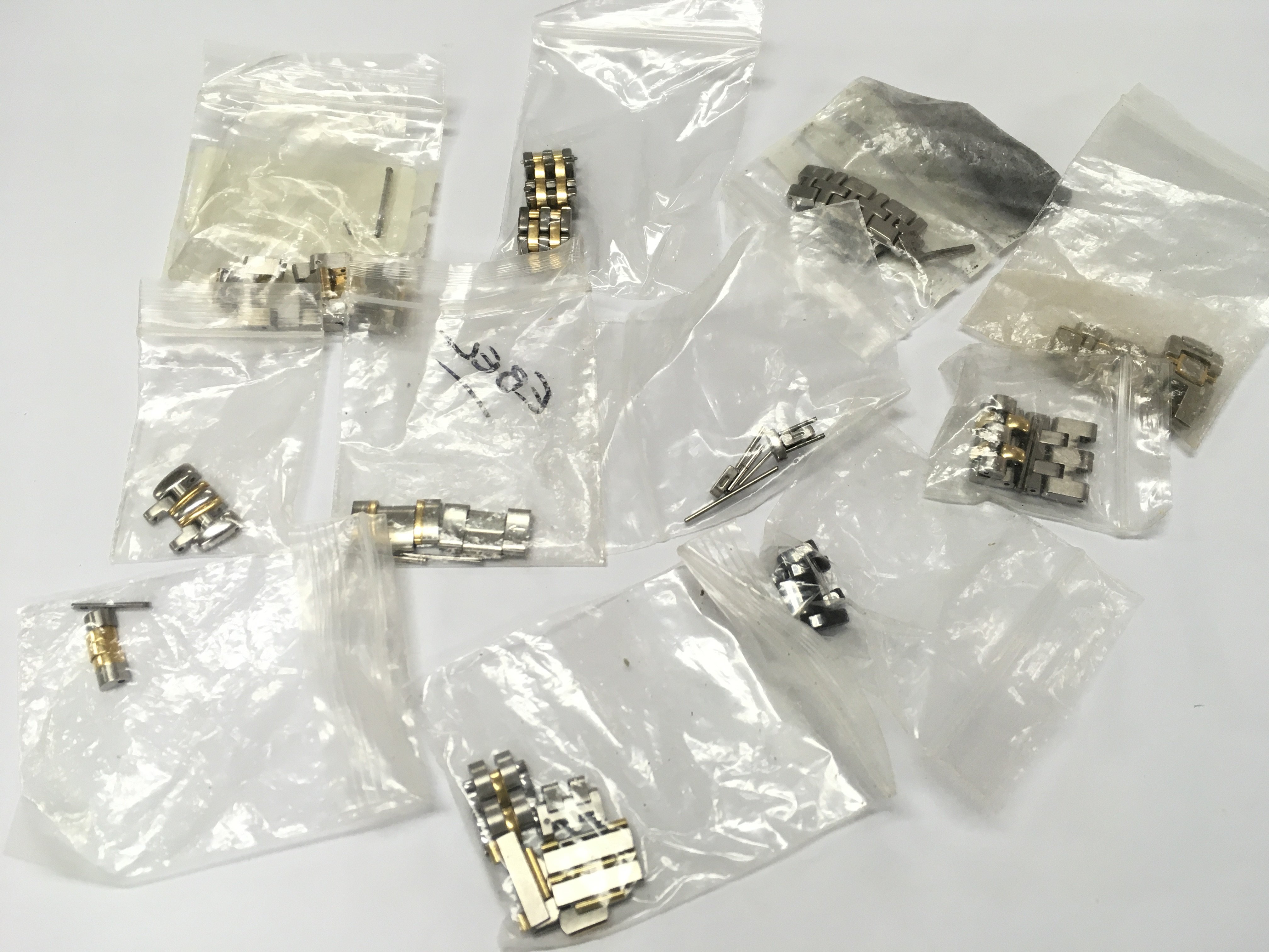 A collection of assorted bi metal watch links various makes.