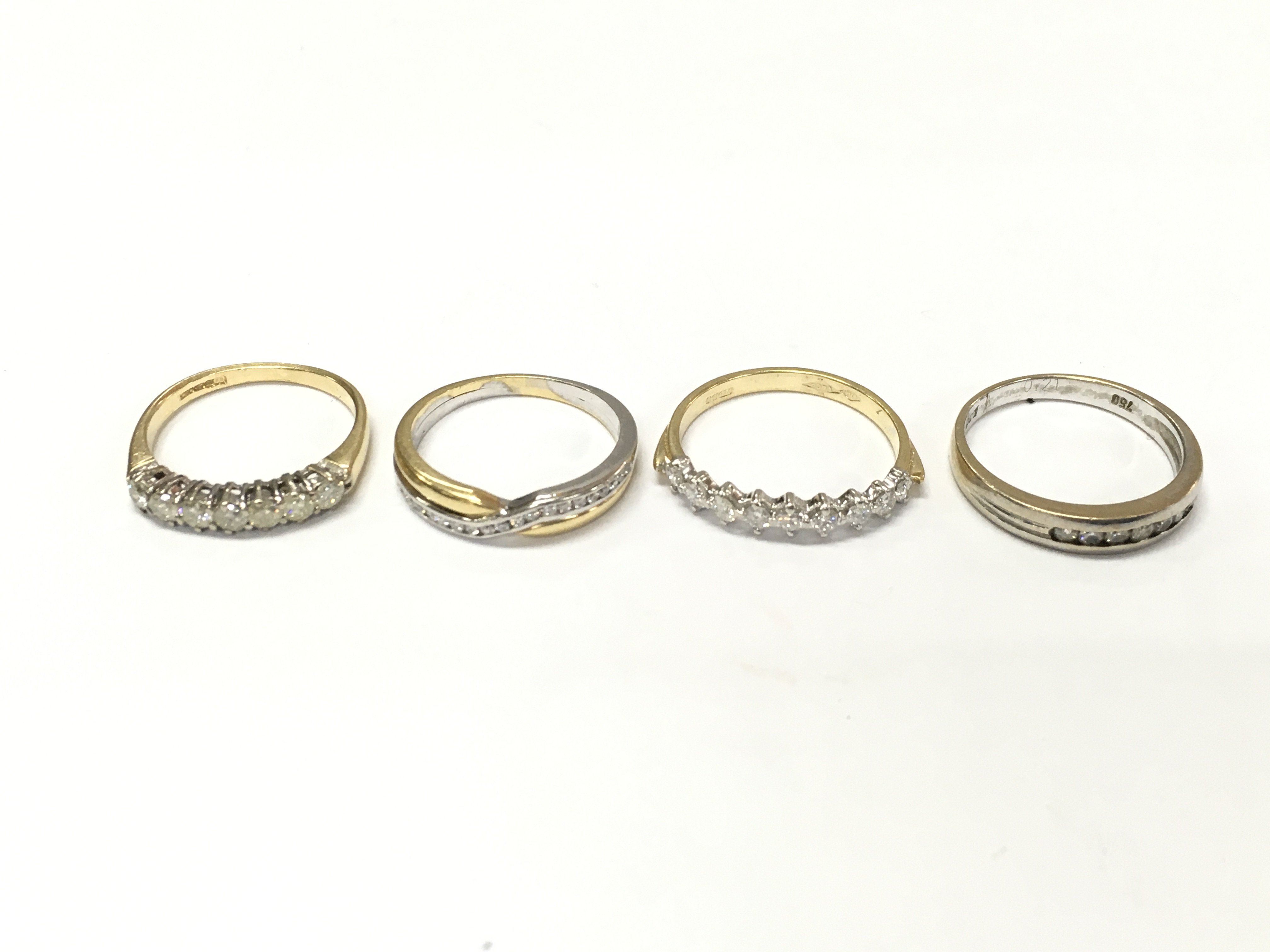 Four 18ct gold diamond half hoop rings. L M 1/2 N 1/2 approximately 10.9g