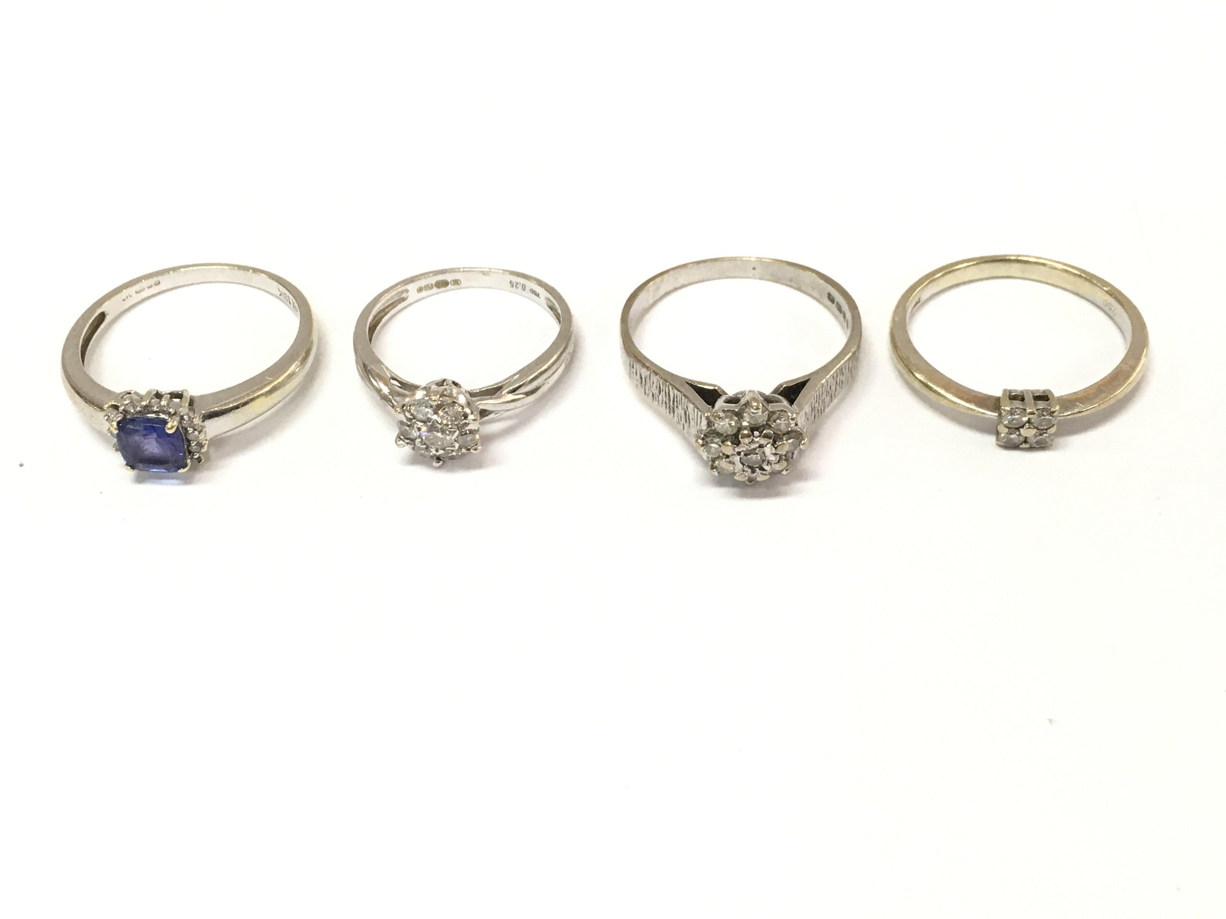 Four 18ct white gold rings with various stones including diamonds. Sizes J L O P approximately 11.1g