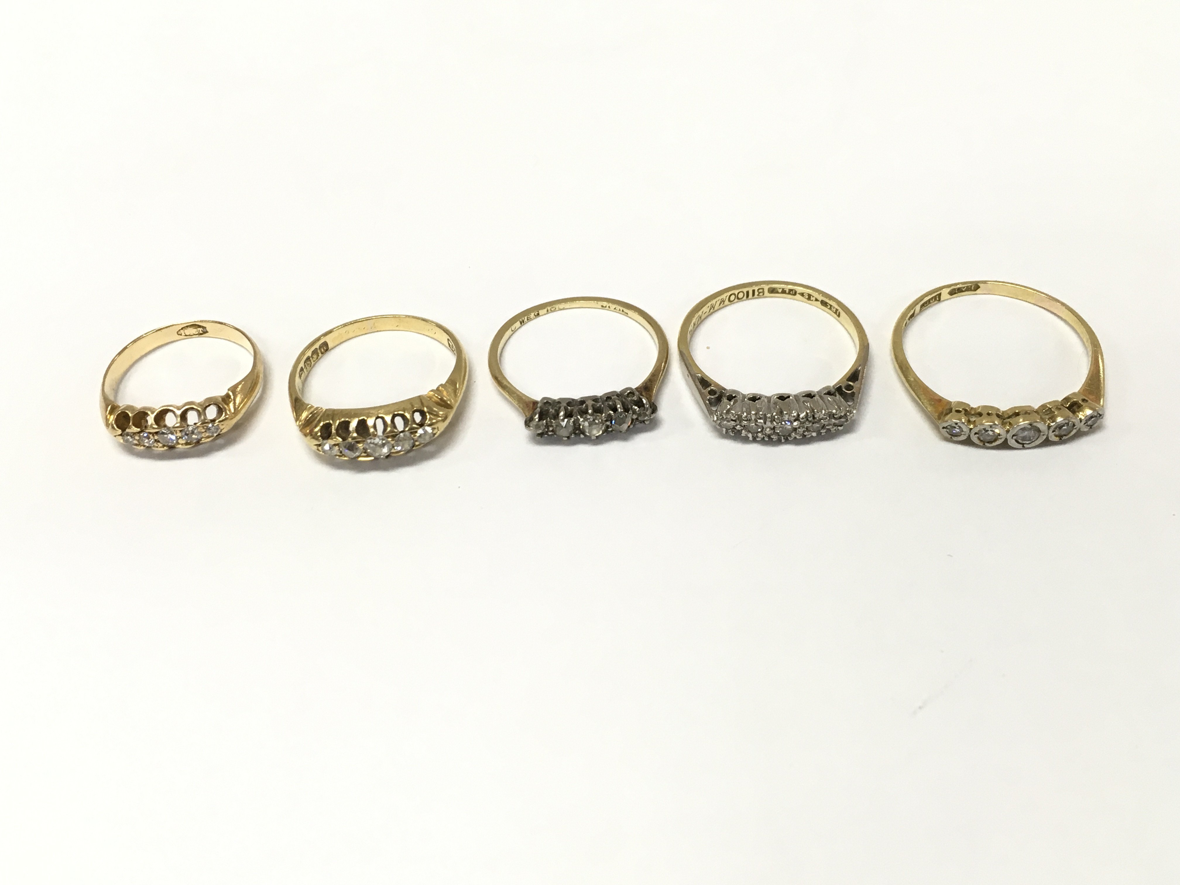 Five 18ct gold diamond five stone rings, sizes H M O R approximately 12.8g